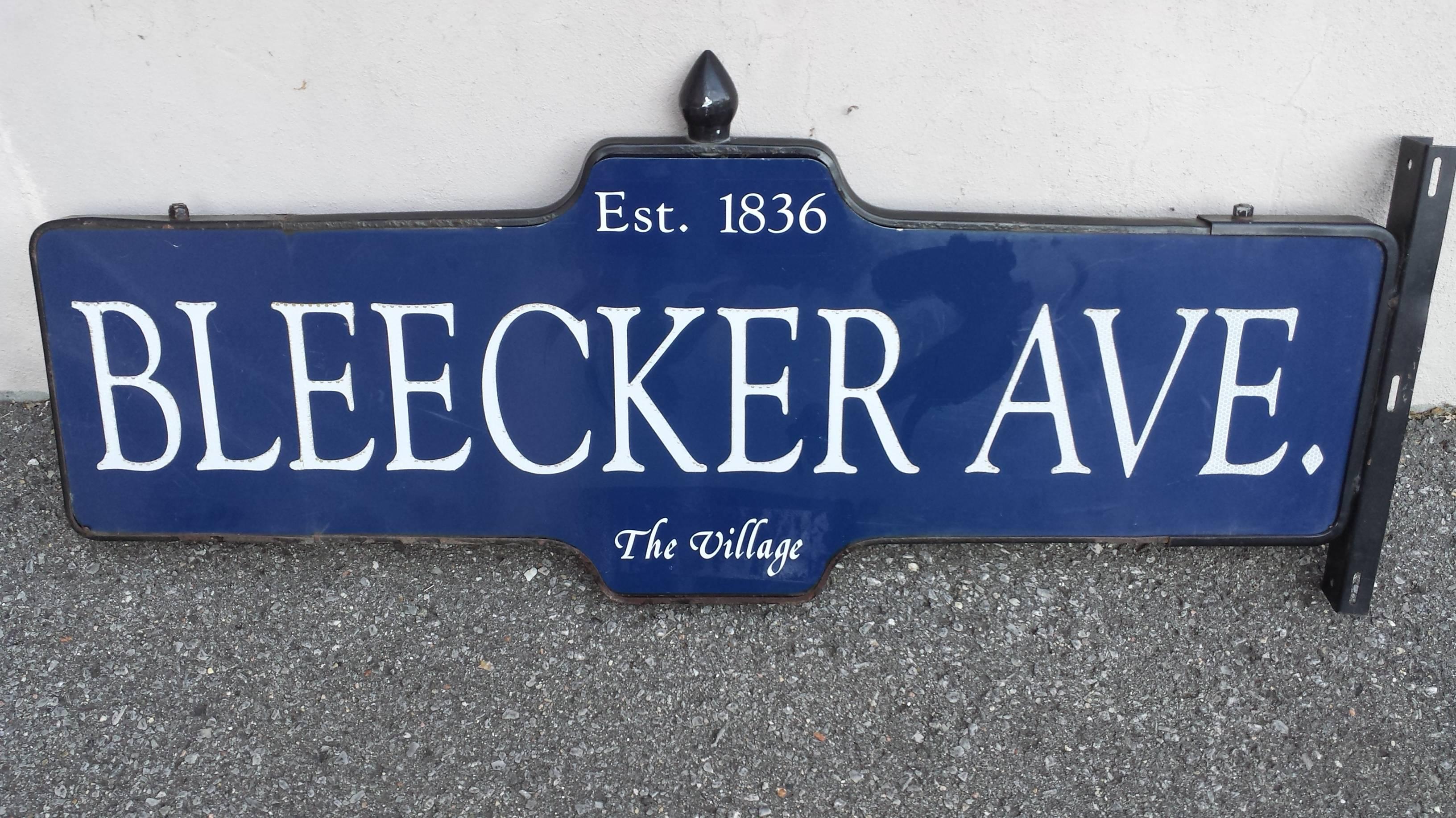 Great iconic, New York street sign 1950s Bleecker ave. located in "The Village" Est. 1836, Black steel frame with decorative finial top and mounting bracket, double sided sign on dark blue background with reflective lettering. The street