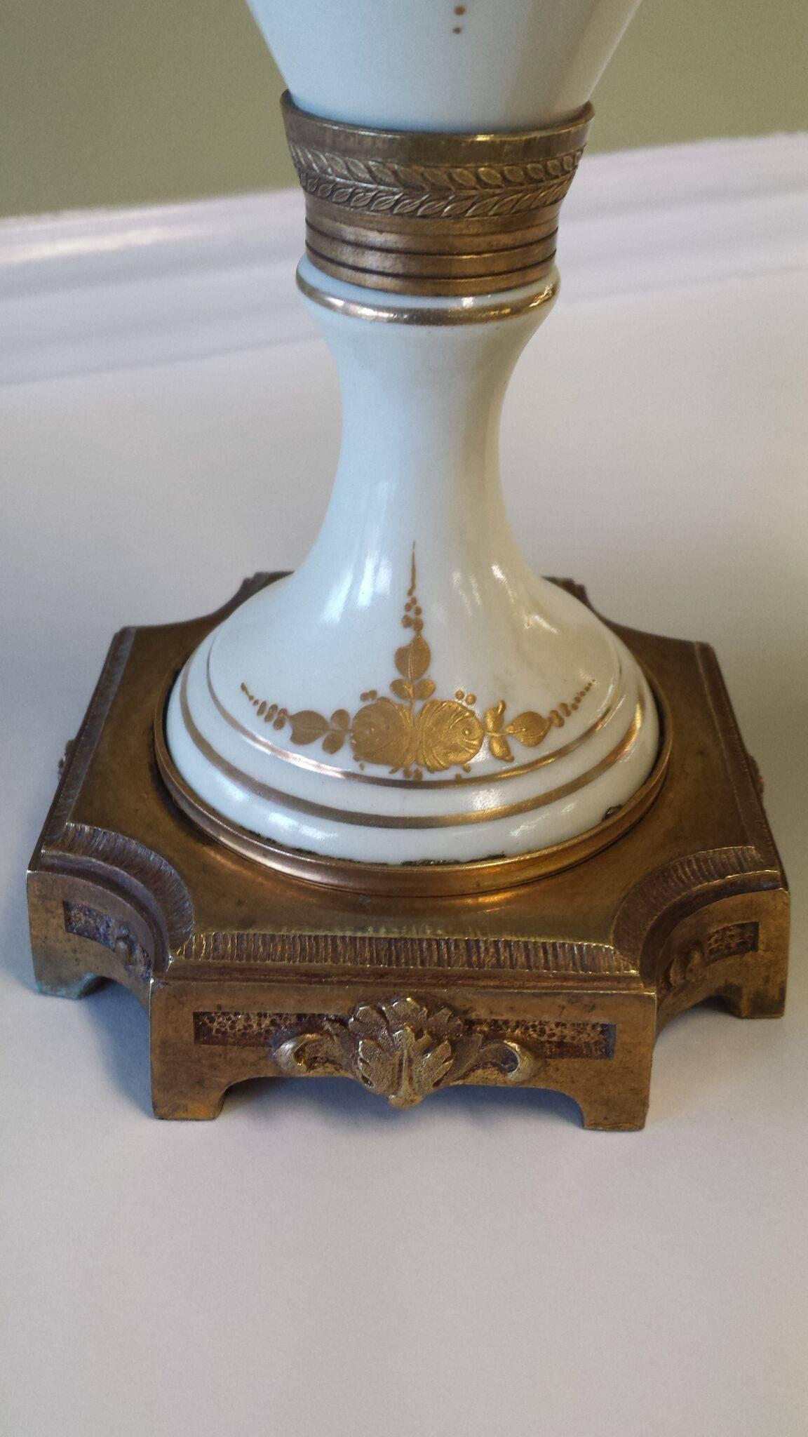 Pair of French Mantle Urns Convertible to Lamp Bases, Factory Done, Made in France in a Sevres style. They are made to be either or, the top unscrews and is threaded for a standard light socket and has a bottom slot with an trimmed wire hole (please