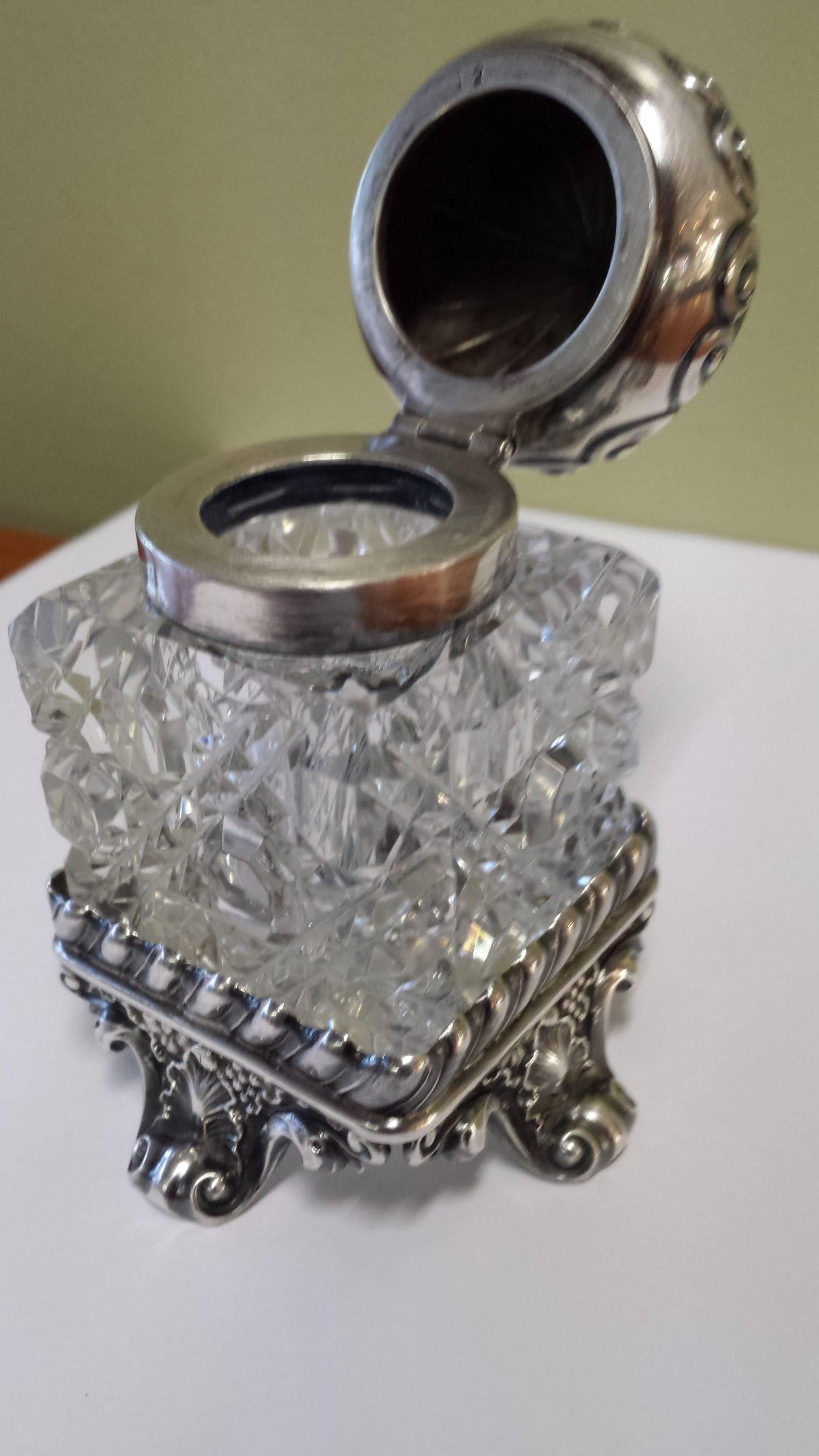 Sterling Silver & Cut Crystal Inkwell With A Seperate Sterling Base. The inkwell has a flip top and a seperate sterling silver detachable base. The inkwell measures 3 3/8"-inches high x 2 1/4"-inches wide. The base is stamped sterling