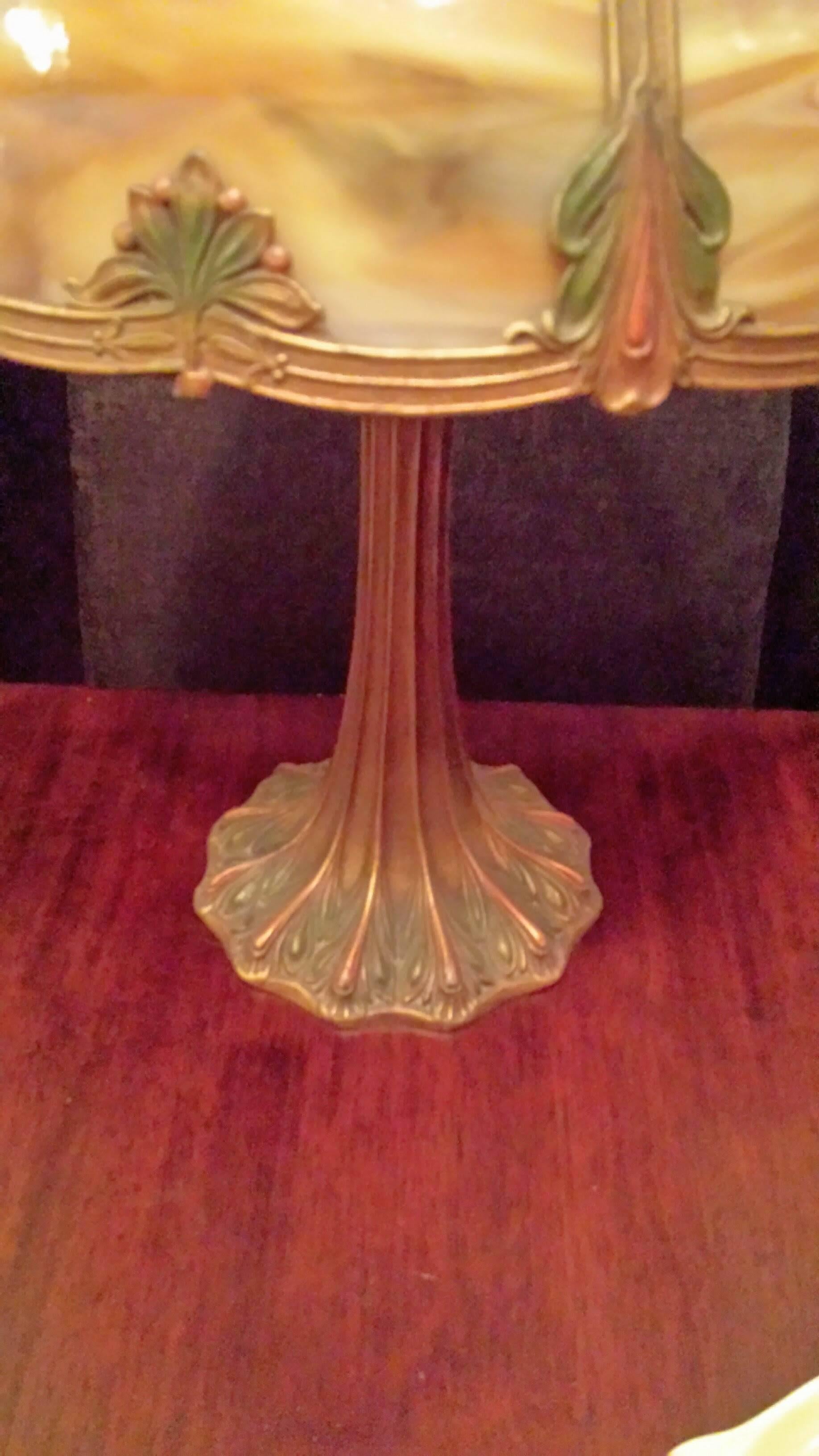 Slag Glass Table Lamp, Carmel Colored Glass with A Leaf Decorated Shade & Base, in Original Bronze/Green & Copper Tone. The lamp has original old glass on all panels, with original finial. The lamp has a newer replaced electrical cord, but with