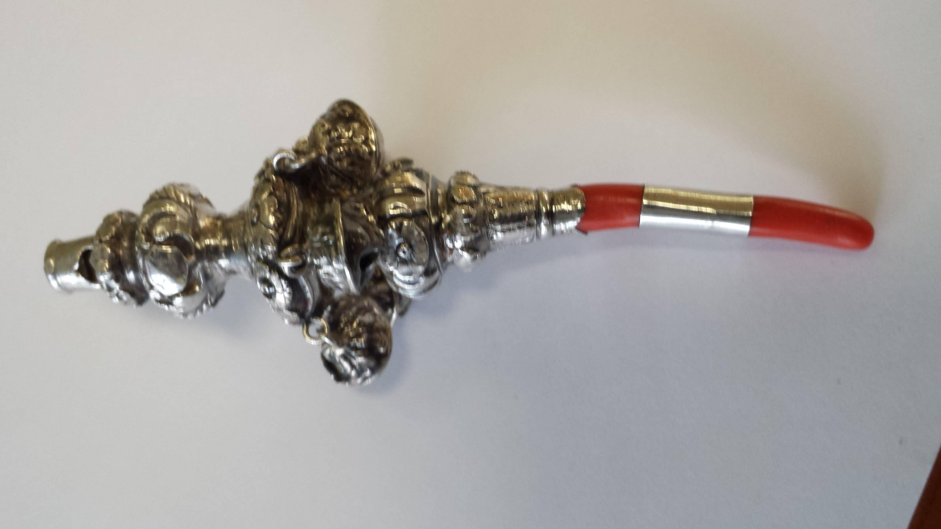 Late Georgian Coral & Sterling Silver Baby Rattle & Teether, Birmingham 1834/1835, Date letter is a K, The rattle has a whistle, chain ring, 6- bell's a band on coral stick teether for a monogram unsigned, Floral and leaf decoraction. The rattle is