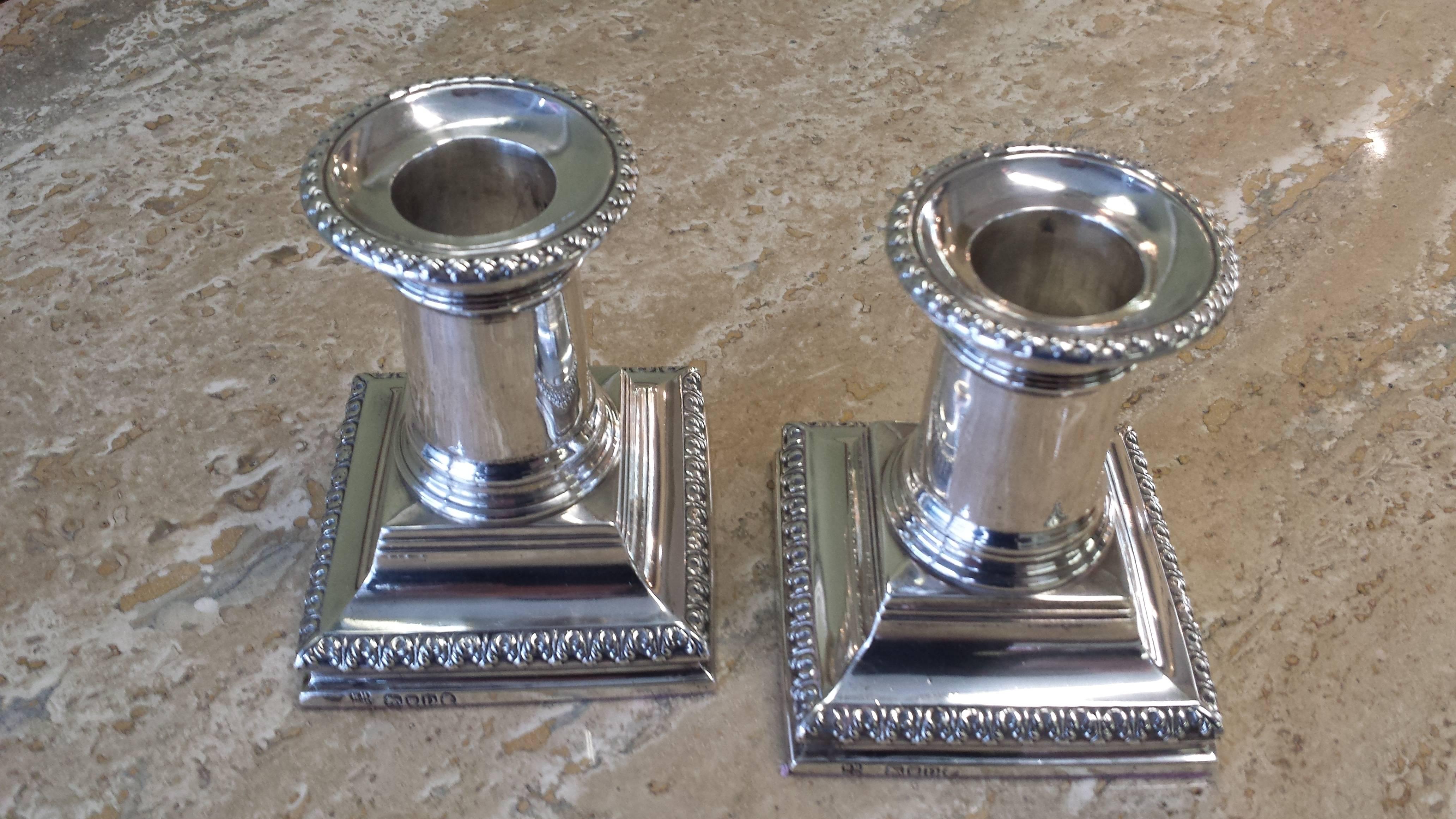 Sterling silver candlesticks, London by Richard Hodd & Son, Hallmarked for 1879, detachable drip tops, smooth column, embossed tops and base, with felt covered bottoms. The candlesticks measure 3 1/2"-inches high x 2 3/4"-inches deep x