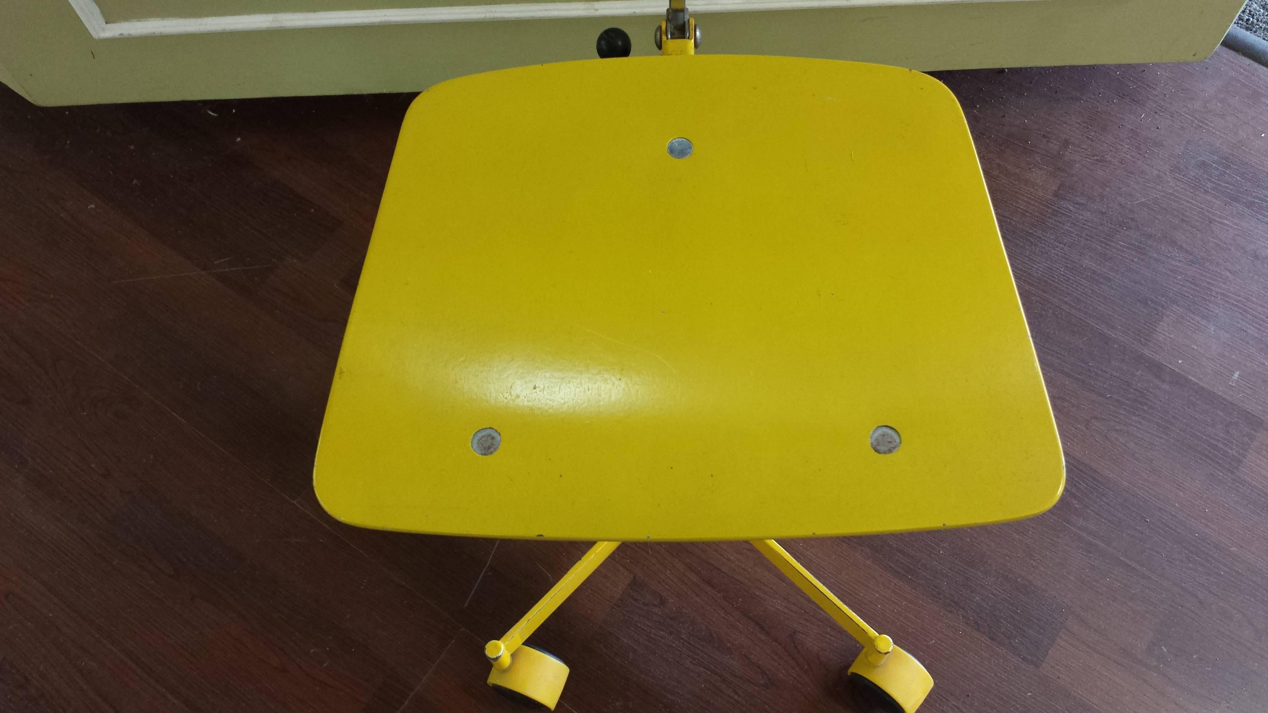 Brilliant yellow Kevi armless fully adjustable desk chair, original label, adjustable seat height, tilting back and adjustable arch back support. The chair is on yellow double wheel casters, original yellow paint but showing signs of wear and slight