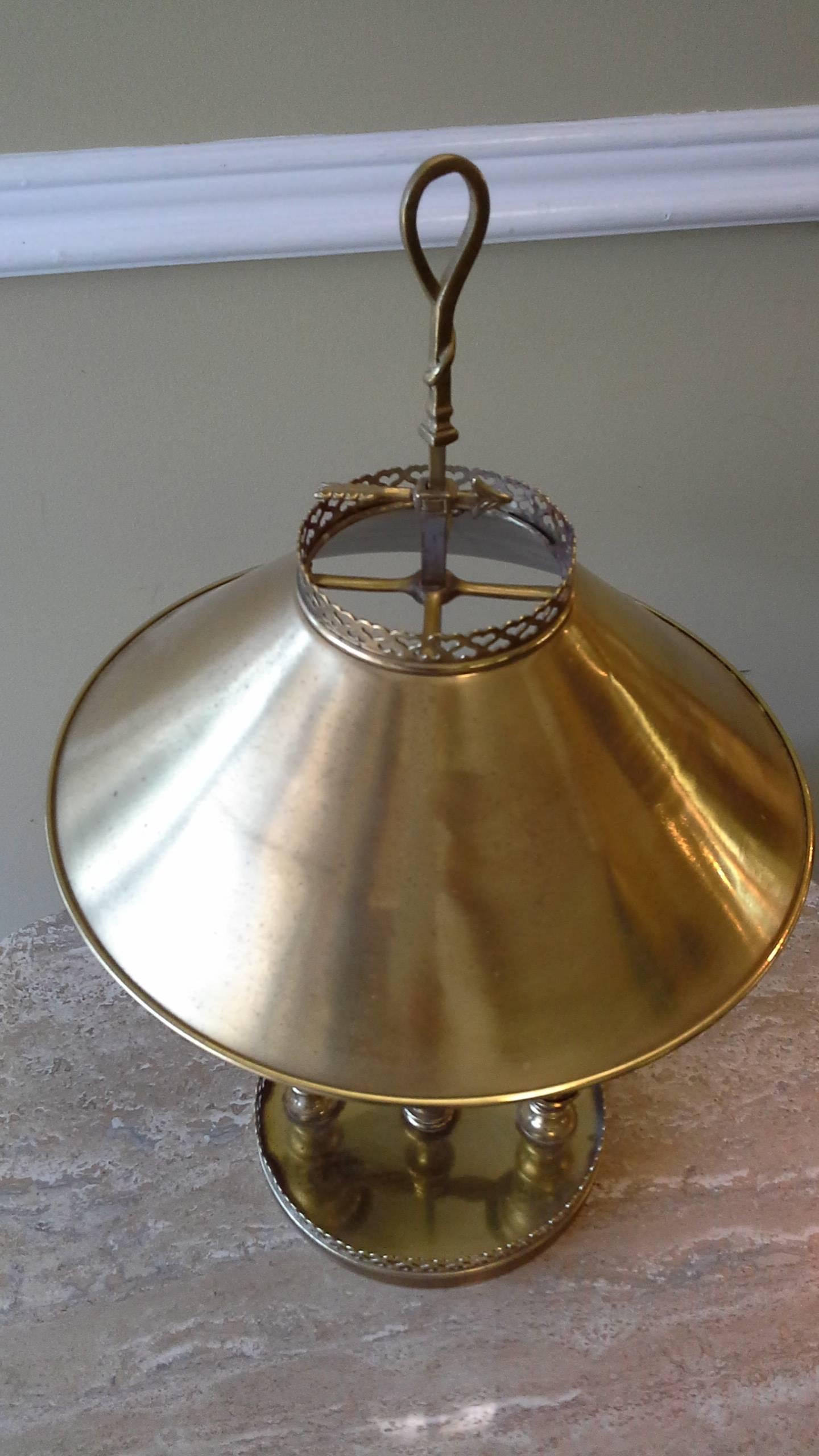 Brass double light desk/banquet lamp metal shade heart pierced round gallery base, the desk lamp has two lights for ample lighting, tray top switch with an adjustable height shade with a arrow set screw. The lamp measures 22"-inches high x