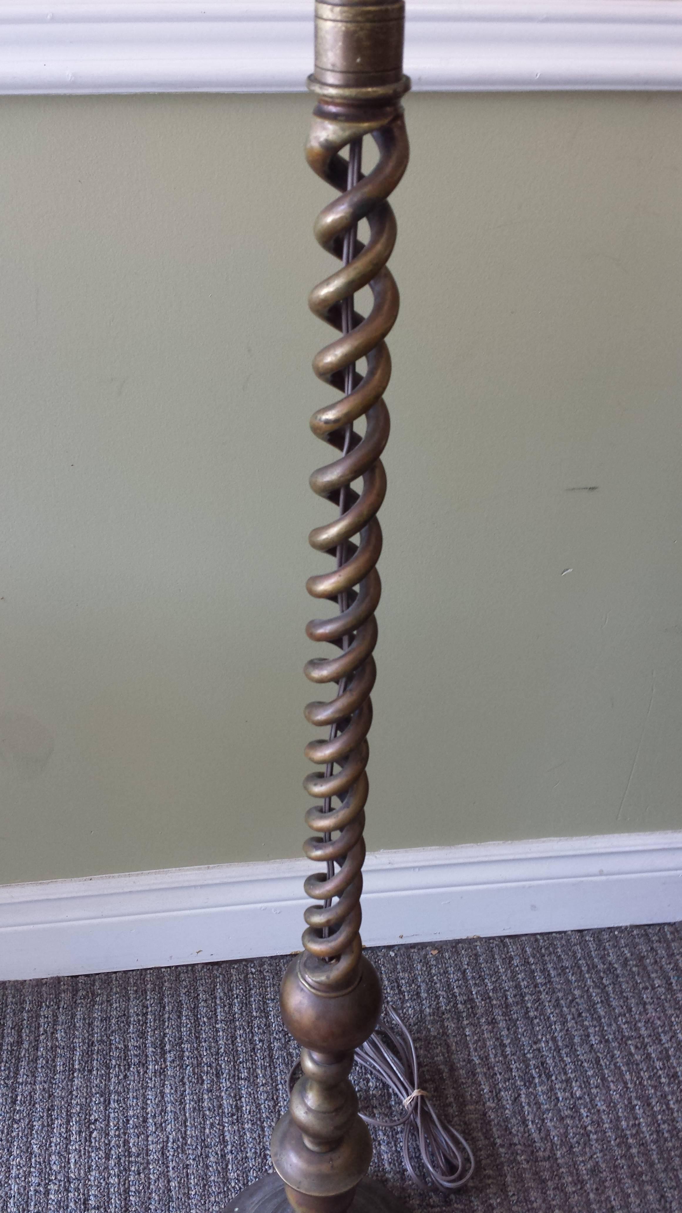 A bronze Jacobean or Barley open twist floor lamp, circa 1910-1915. The lamp has double sockets, (one replaced) and new wiring in brown. The lamp has a wonderful patina, color and presence. The base is nicely weighted and holds the lamp upright. An
