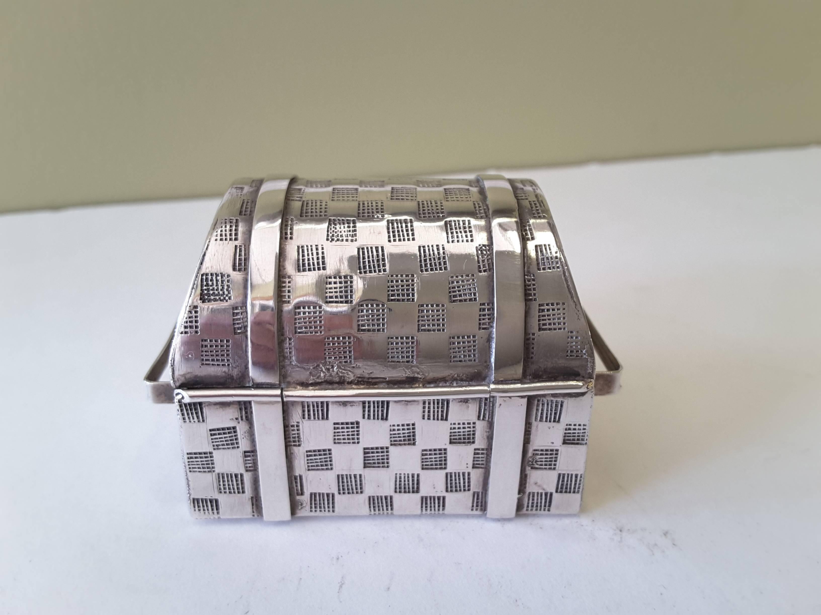 Miniature dome top treasure chest box marked .925 Peru, with Sun God stamp. The Trinket box is in the form of a treasure chest, woven pattern and straps with open handles on the side and the front has working movable hasp for a lock.
Great little