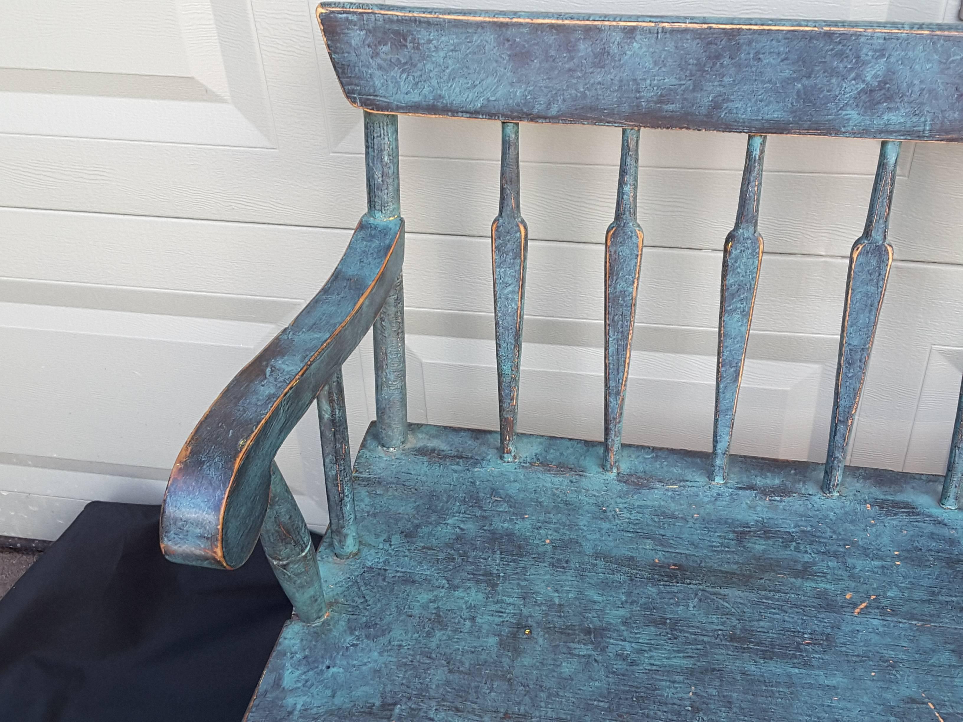 A pine spear back windsor two-seat settee, in a great turquoise blue.
American new England bench, nice scrolled arms, spear back slats and a flat elongated spear head shaped stretcher. The bench has turning on the front legs & arm front supports,