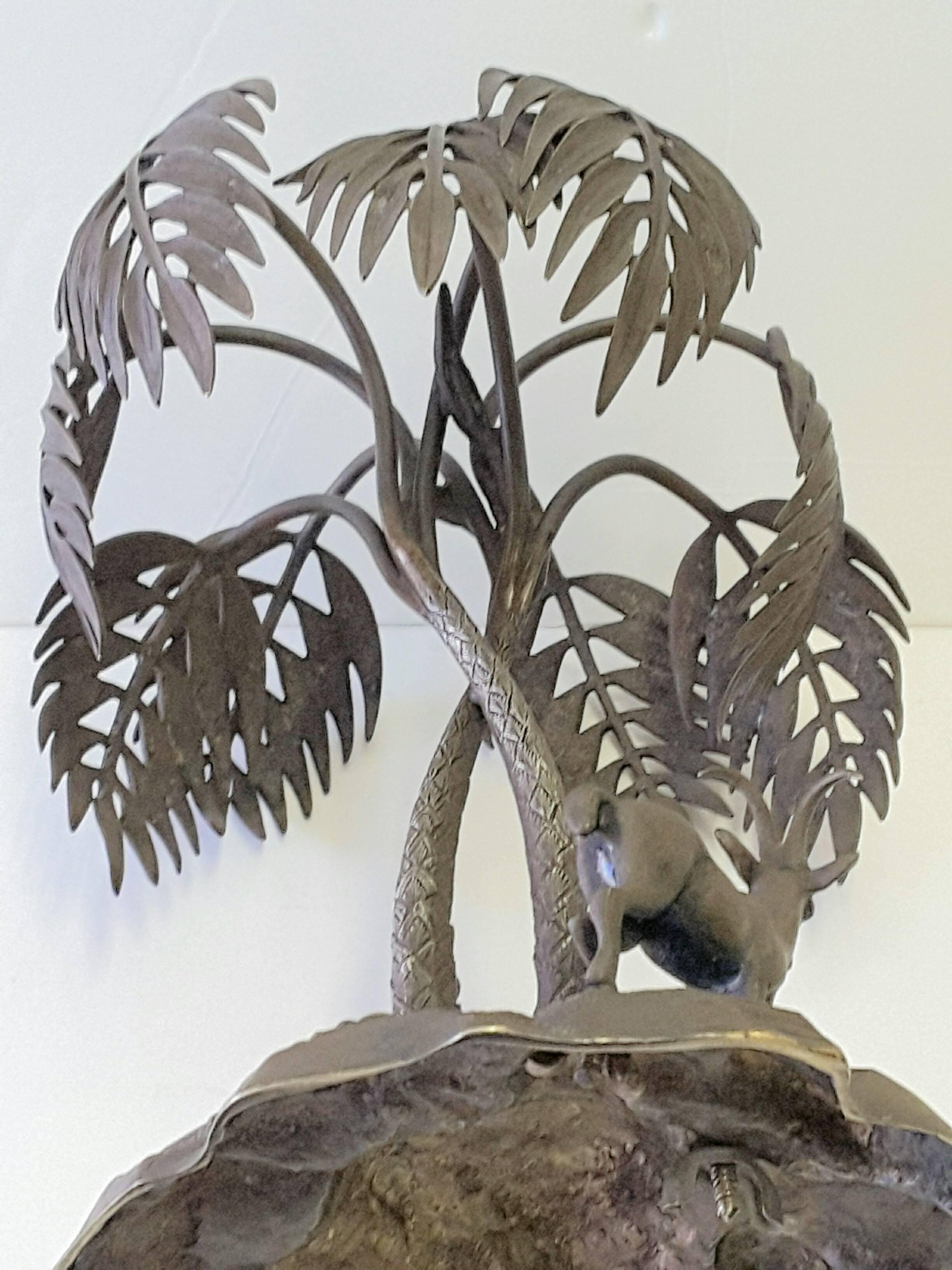 Scultura in bronzo con palma e gazzella su una base di roccia, con il marchio T. T.W. sul lato della base. Bella la patina e le dimensioni. La scultura misura 10 pollici di altezza x 9 pollici di diametro. Mid-Century Modern, circa anni '70.