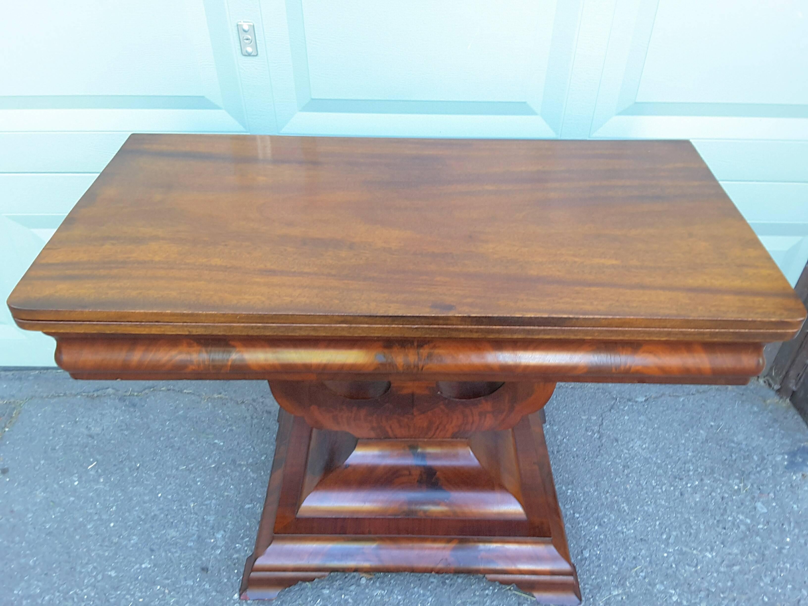 A fine Regency flame mahogany Lyre style based side table games table in a Regency style. When closed it makes a perfect side table/breakfast or console, when open it is a square table that can be used for serving or dining. The table is on a