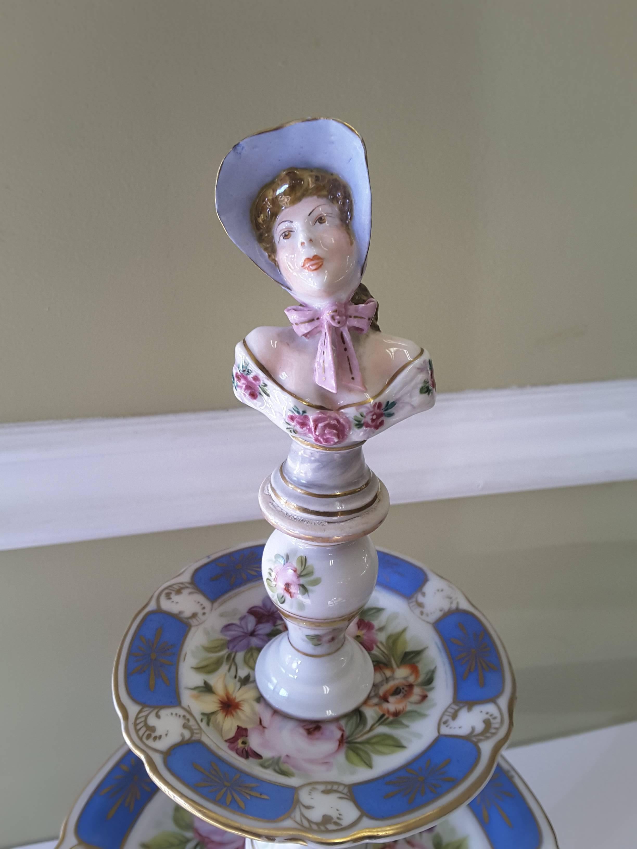 A rare Paris figural porcelain three-tier dessert Tazza, three graduated plates with floral decoration, gilt and 