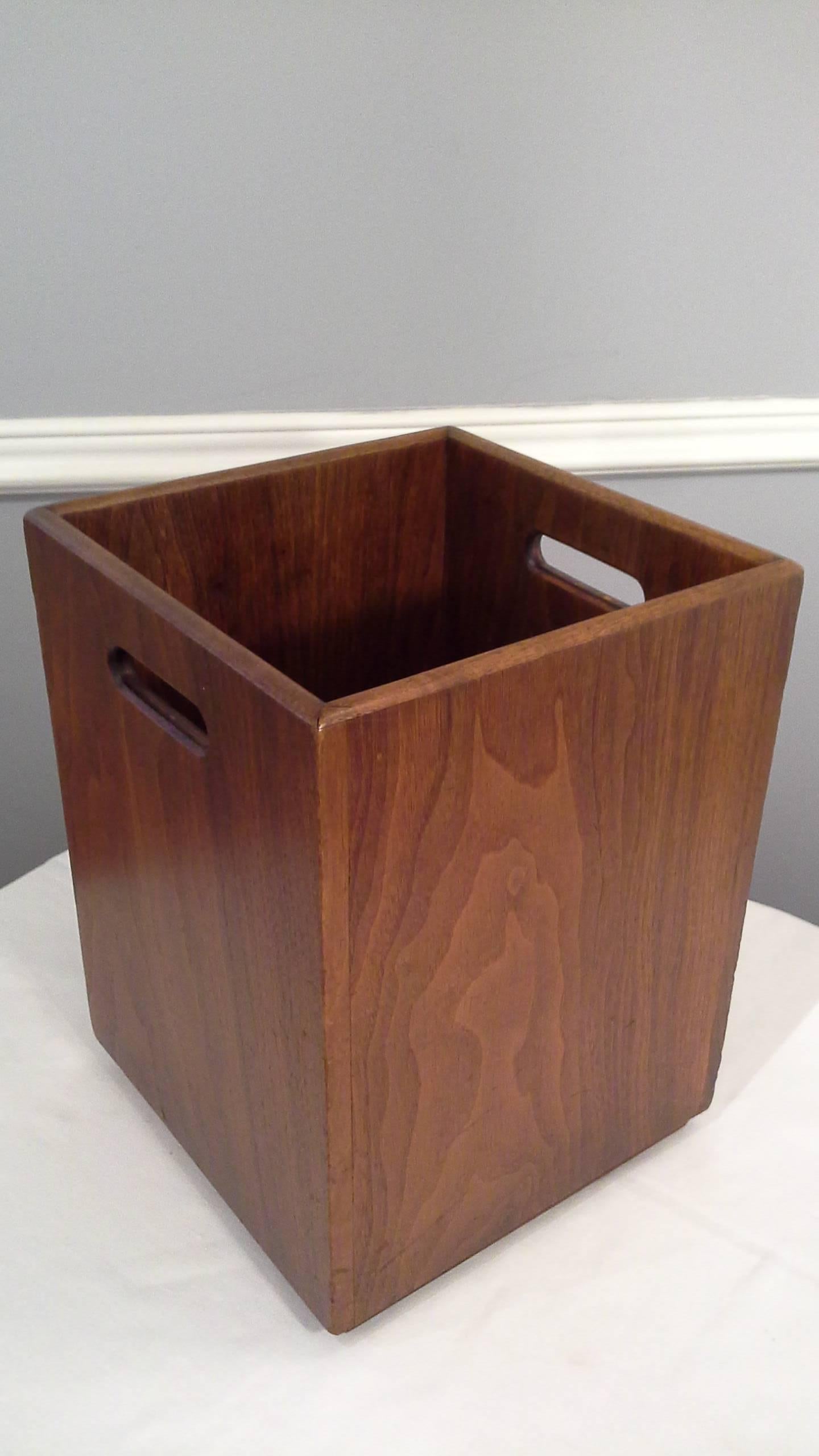 Mid-Century solid walnut waste baskets in a medium brown walnut finish. The baskets have two handle cut-out on opposite sides, the baskets are on a 1"-inch high base & measure 11"-inches x 11"-inches x 15"-inches high.
Note: