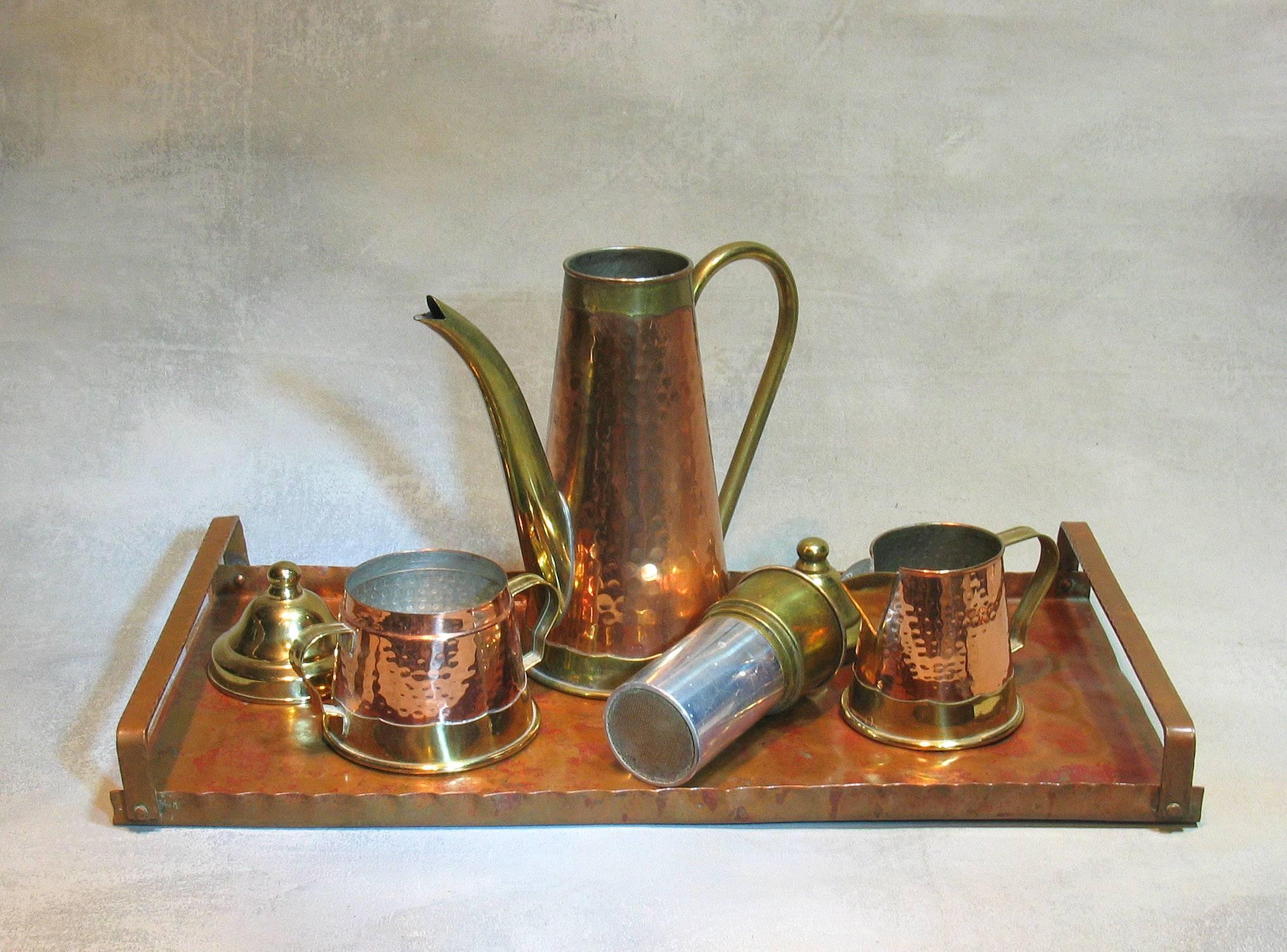 An exquisite planished copper and brass coffee set, By Dinanderie de Mecap, Made in Belgium. The four piece set consists of a tall coffee pot with interior filter, creamer, and sugar on a matching rectangular copper tray with handles. Made in