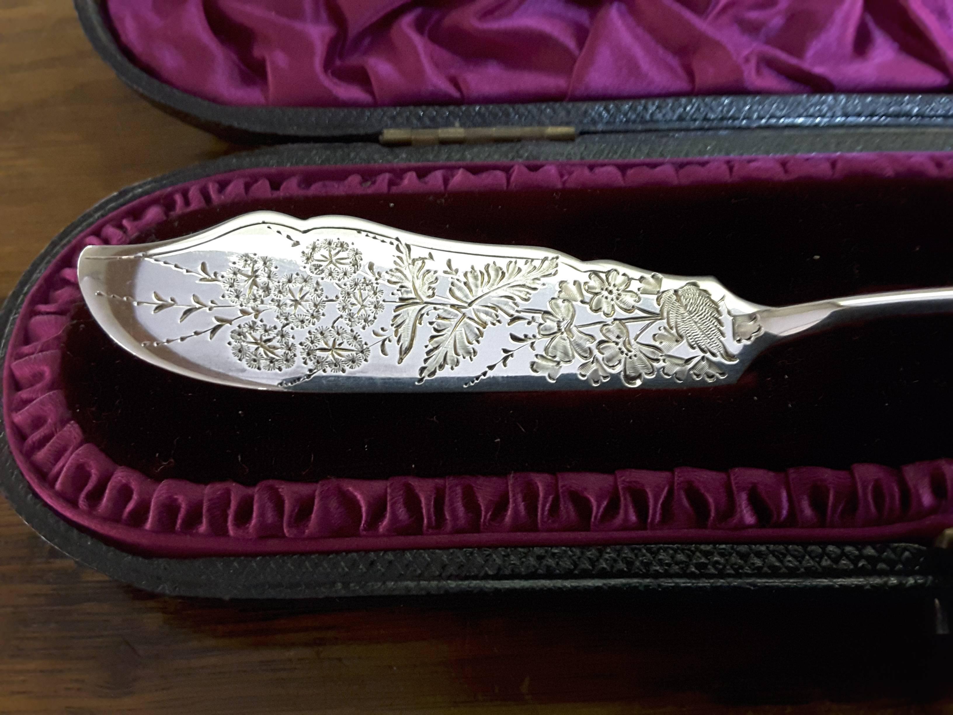 A sterling silver butter knife in a presentation case, London, hallmarked 1886, makers mark HA for Atkin Bros. (Henry Atkin). A nice sterling silver butter knife with detailed decoration, hallmarks on back, in the original leather case. The knife