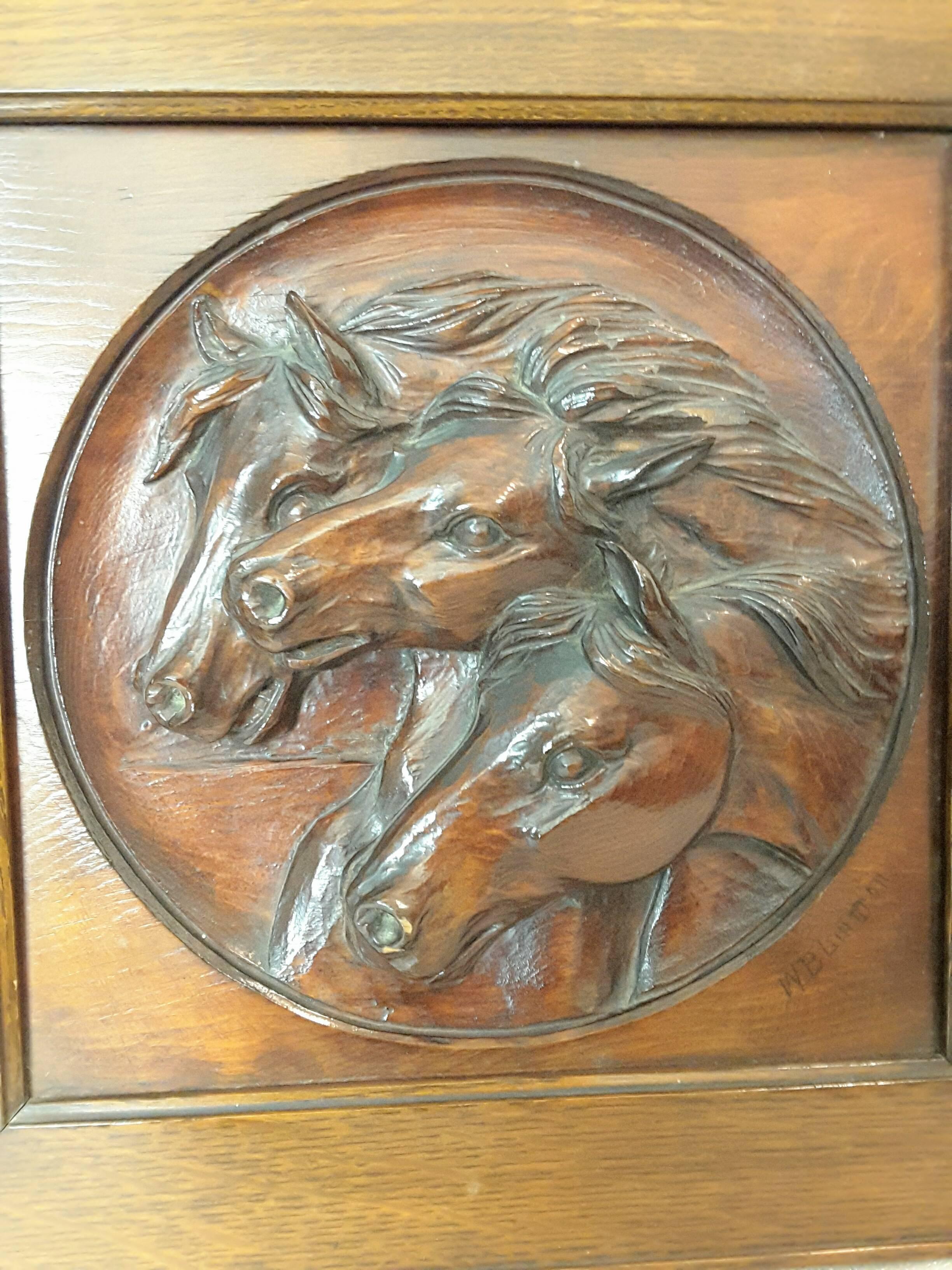 A nice three horse carved pine panel mounted in oak frame signed W.B.Lintton, The horses are deeply carved In a round recessed disc. The carving is signed on the lower right, W. B. Litton. The carving is mounted in a quarter cut oak frame. The