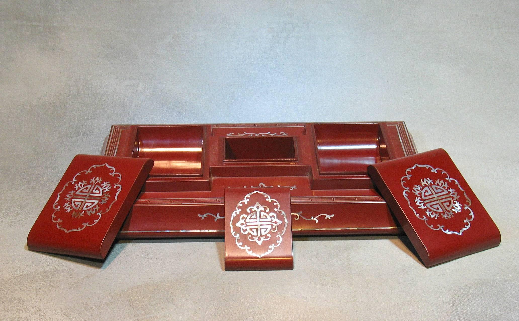 A rare antique Chinese red lacquer desk box of cove sided rectangular base with three lidded compartments each with 