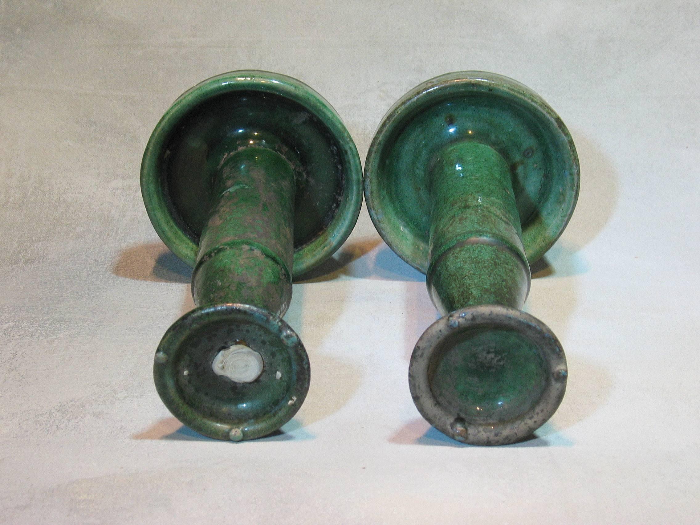 Shiwan pottery oil lamps late qing dynasty or earlier, South Chinese, two-pieces, with saucer base, hollow cylinder column tapering to a cup with three spurs. Thick crackled glaze pooling at the base. The taller of the lamps with makers for