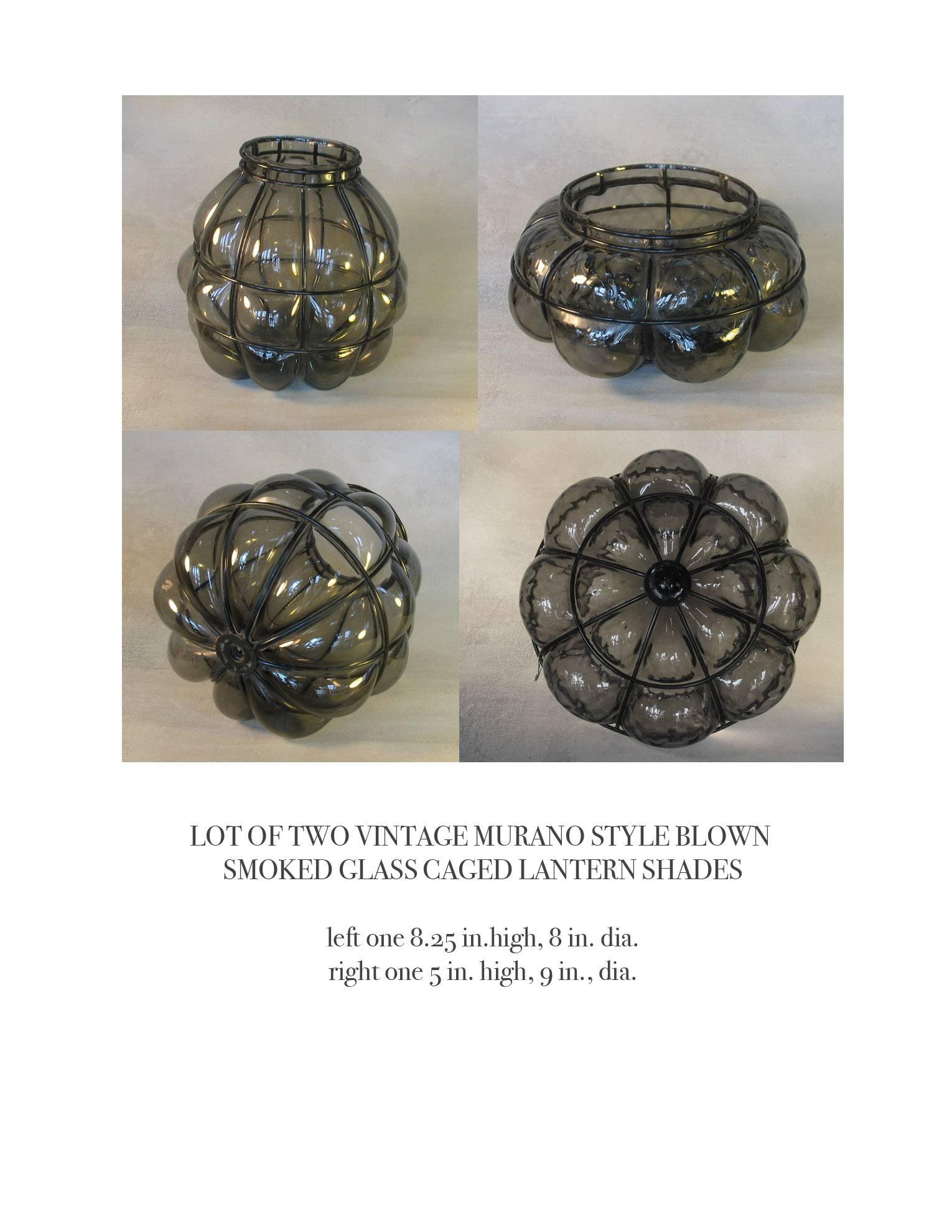 Lot of two vintage Murano style blown smoked glass caged lantern shades, caged in a wire basket form with extended globe protrusions. The shade on the left measures 8 1/2