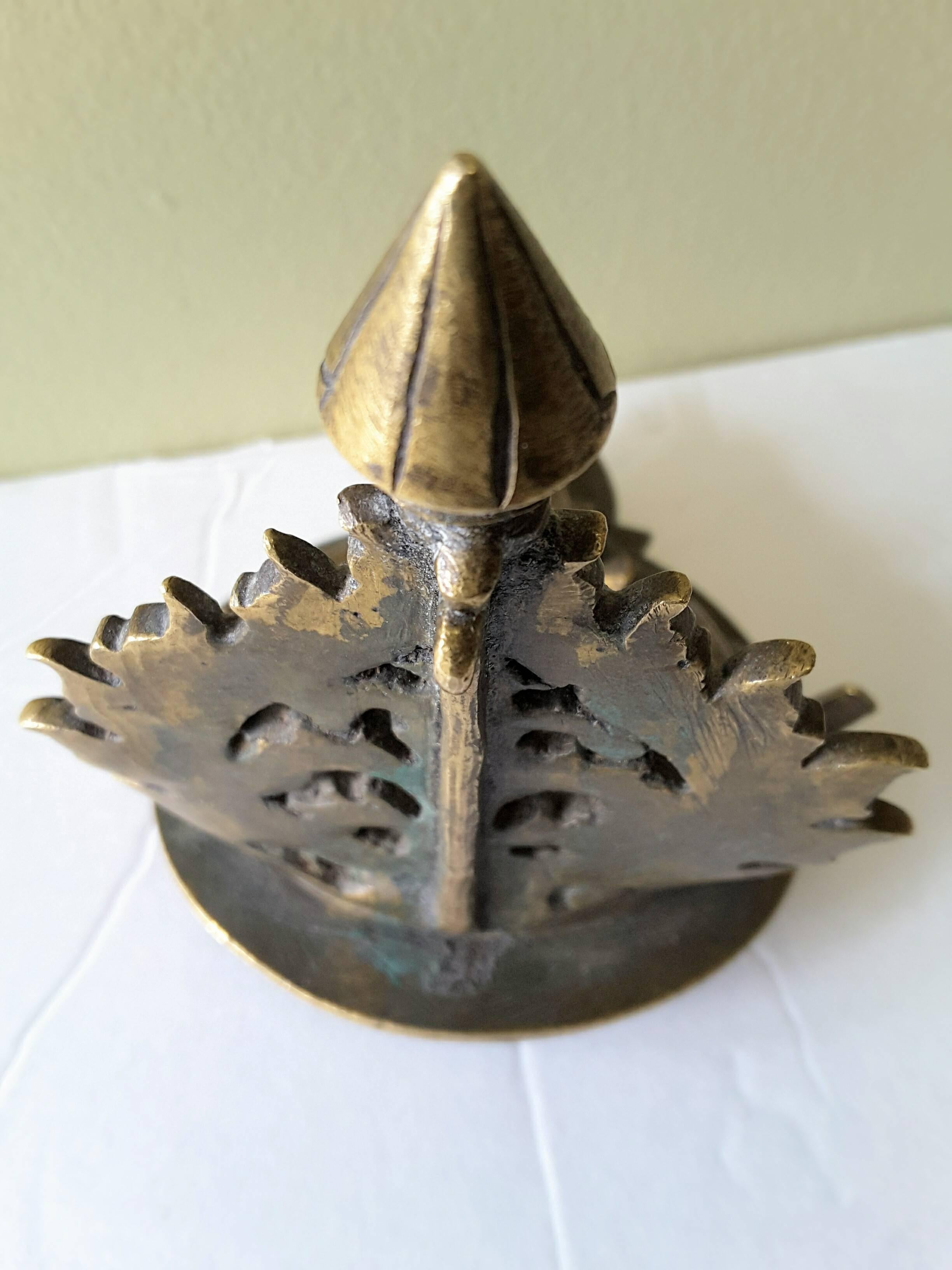 Bronze South Hindu Ritual Oil Lamp with leaf and foliage detail on the upright back with a nicely aged patina, untouched condition and has not been cleaned. The oil lamp is early 19th century or earlier.
The oil lamp measures 4 1/2" inches high