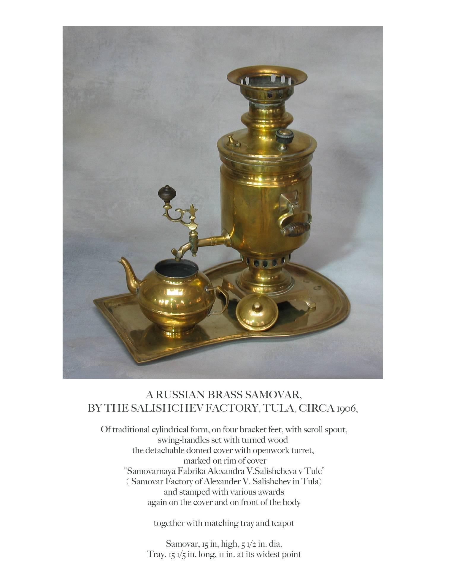 A Russian brass samovar, By The Salishchev factory, Tula, circa 1906, of traditional cylindrical form, on four bracket feet, with scroll spout, swing handles set with turned wood. The detachable domed cover with openwork turret, marked on rim of
