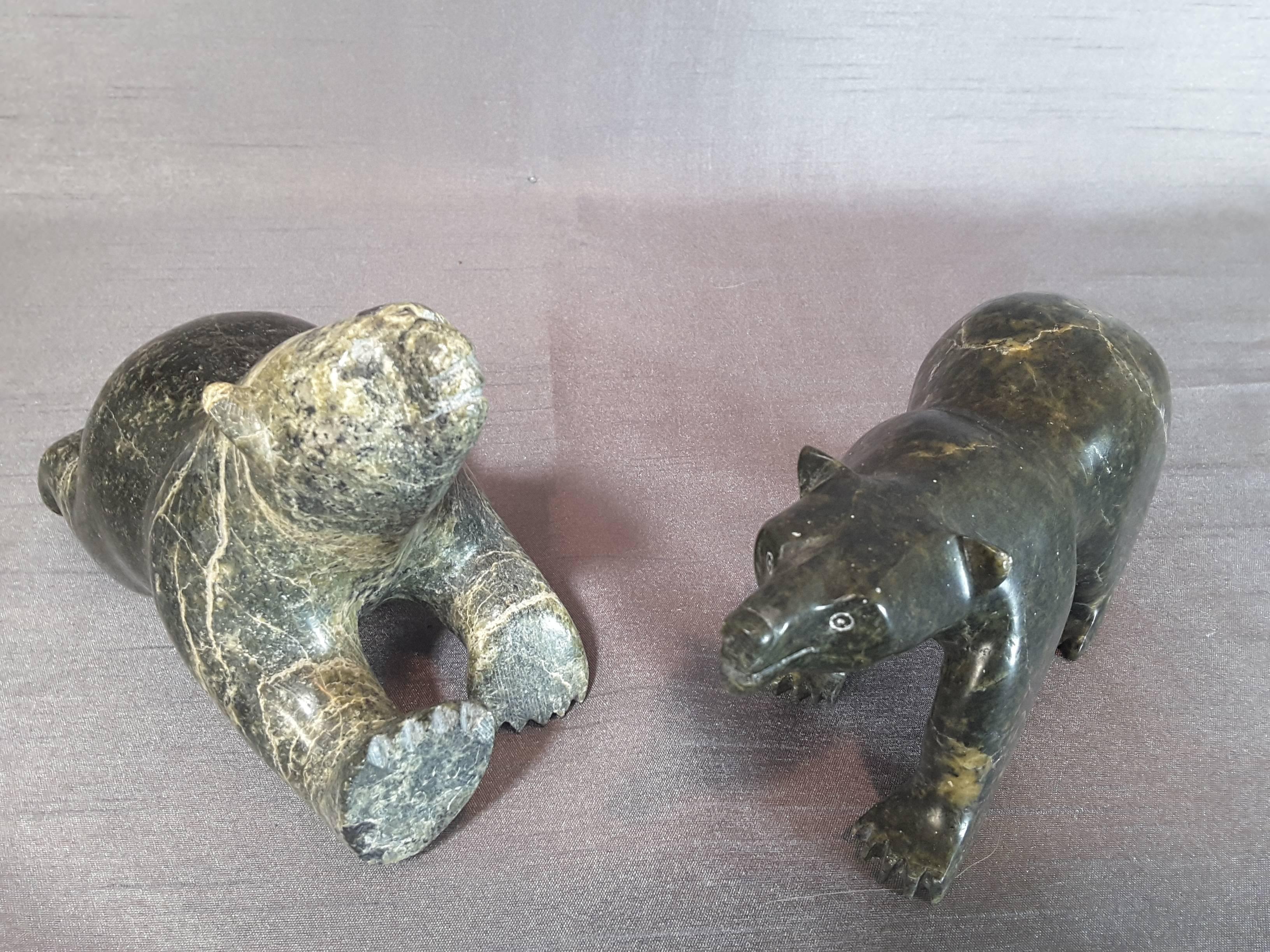 Pair of Inuit soapstone bear sculptures, circa 1960-1970, The pair of soapstone bears consist of one bear standing and the other one in a lying position. Both are carved with green soapstone, one in a light green and the other in a darker