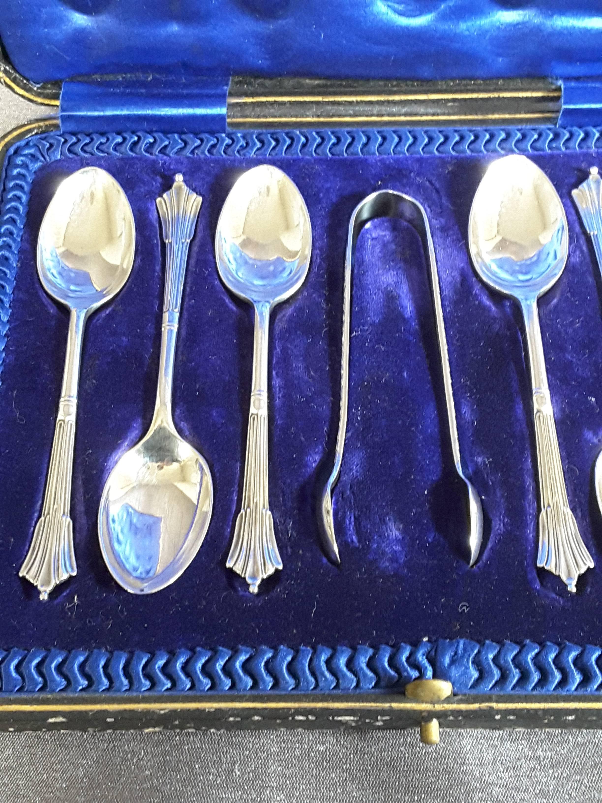 A boxed set of Demi-Tasse sterling silver spoons with a set of sugar tongs, the set consists of six demi-tasse spoons and one set of sugar tongs, Hallmarked on verso for London, 1912, Maker is Atkin Brothers. The spoons are 4 1/2