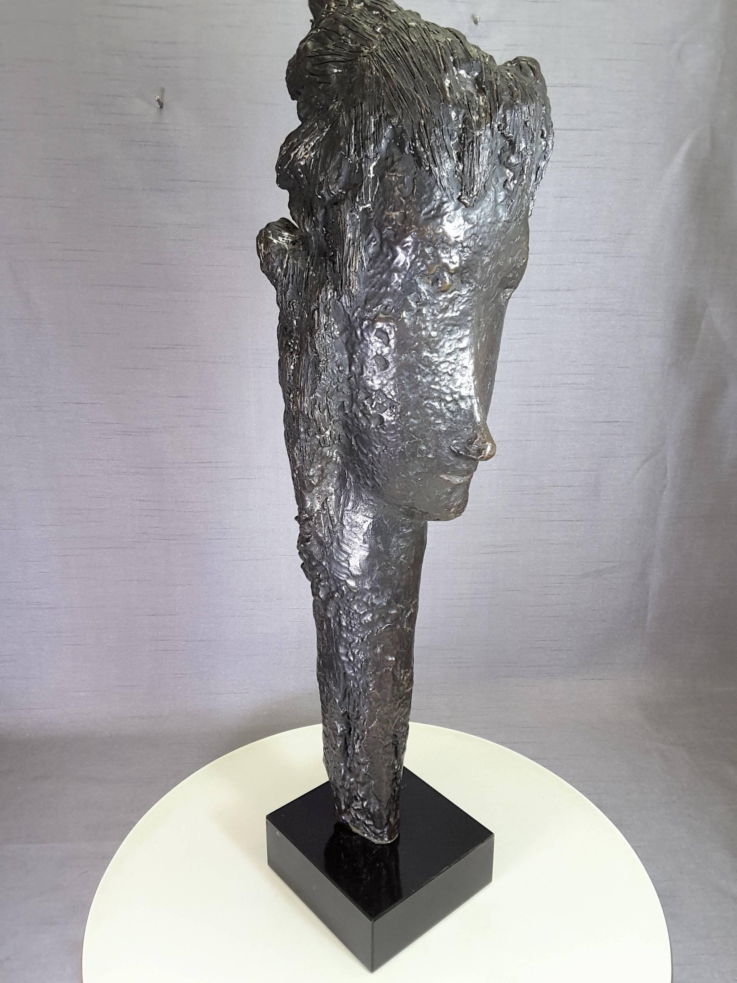 Tall head bronze sculpture by Almuth Lutkenhaus (1930-1996), Modern style head figure with elongated neck, mounted on a black square base. Very Modern in style with the back of the head showing flowing hair. The head measures 24