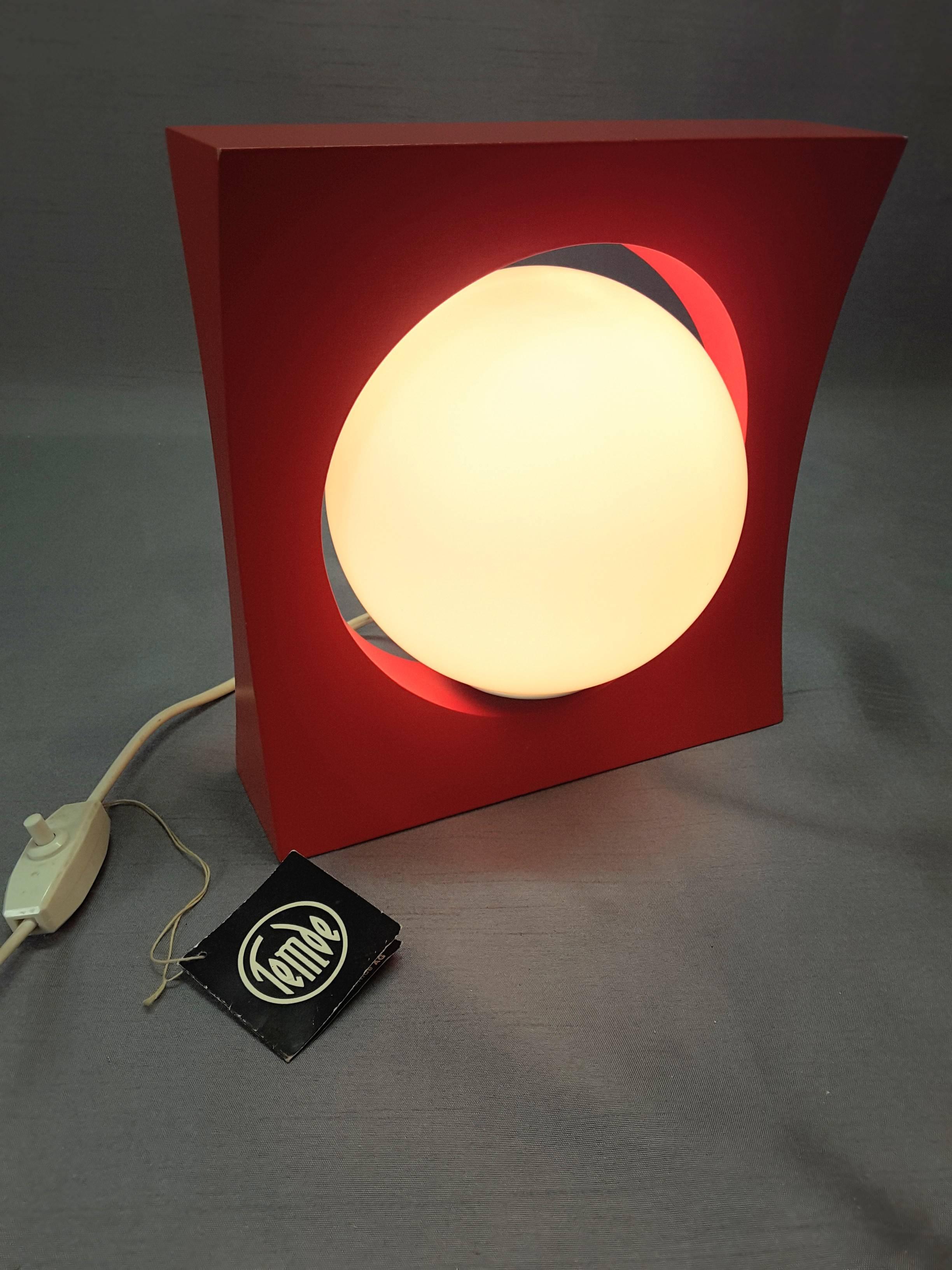 Temde bright red floating ball table and/or wall lamp Mid-Century Modern, made in Germany. Fabulous bright red color and design, the interior ball pivots in all directions, on a white milk glass shade, the lamp has a concave square frame, can be