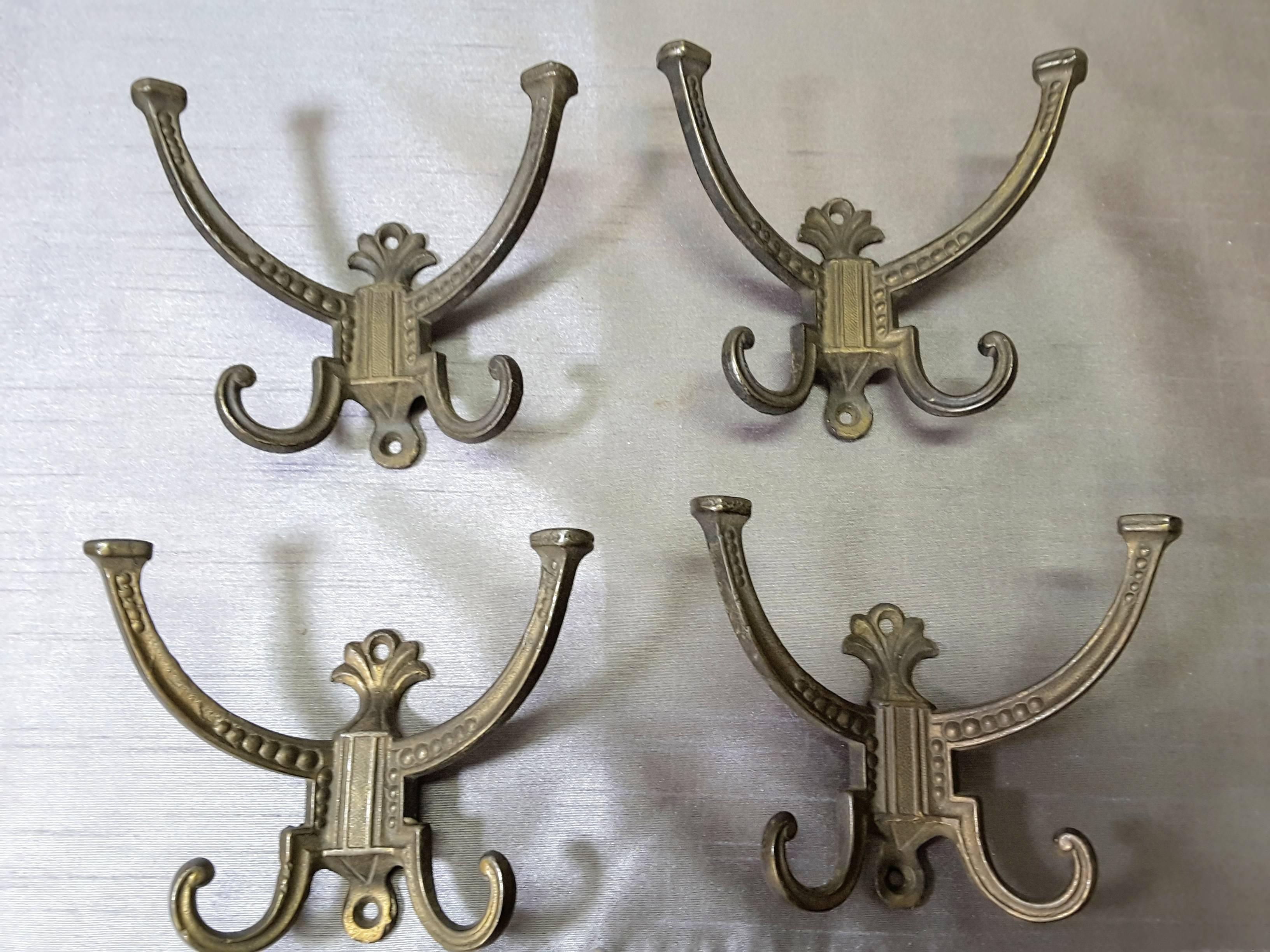 Victorian hallstand or coat stand hooks, set of four, dated 1878 and marked H.B. The hooks are four prongs on each hook, with upper and lower screw mount holes, made of cast iron, each hook is marked on the back centre. The hallstand hooks measure 5