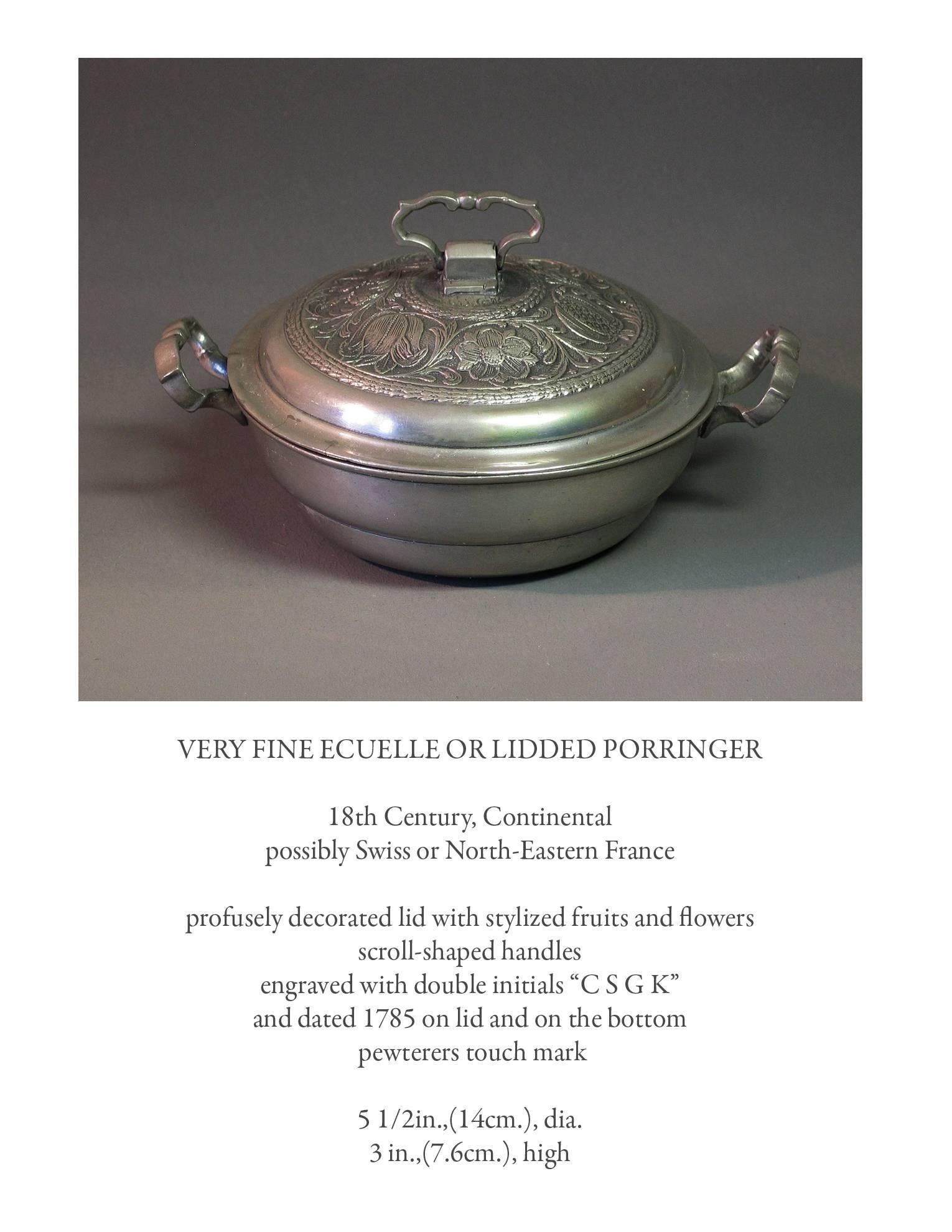 Very fine Pewter Ecuelle or lidded porringer, 18th century, continental, possibly swiss or north eastern France. Profusely decorated lid with stylized fruits and flowers, scroll shaped handles engraved with double initials 