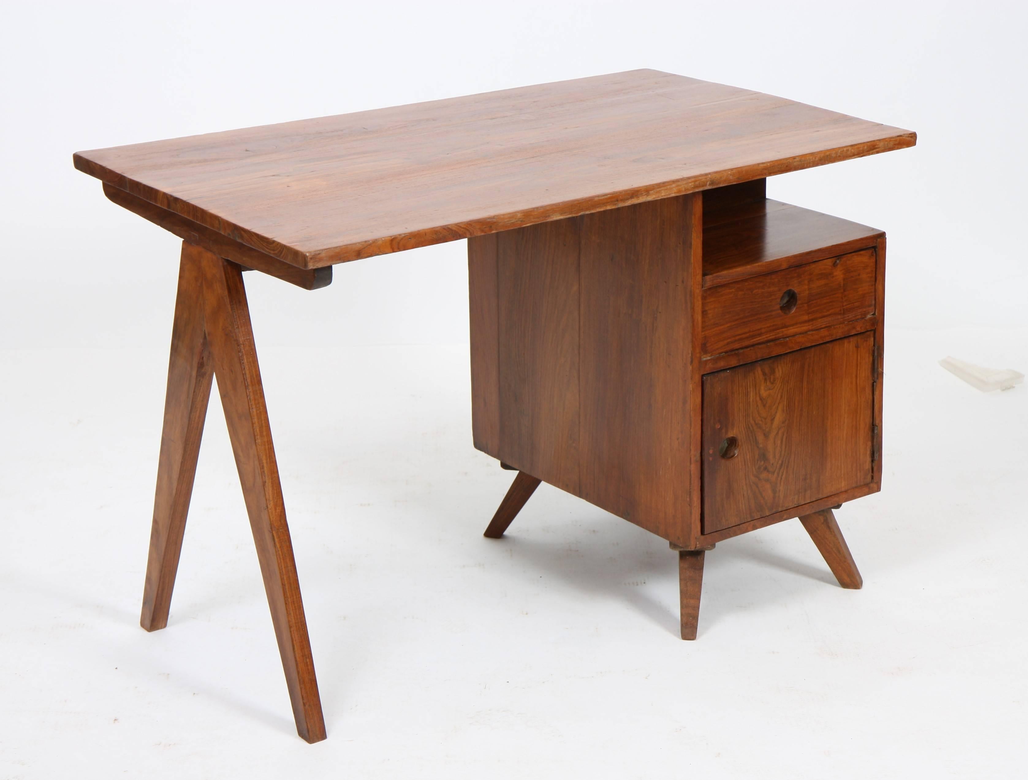 Pierre Jeanneret (1896-1967).
Small administrative desk, solid teak, tray mounted on "V" leg on a trunk opening with a door and a drawer on the opposite side,
circa 1960.
Measures: Height 69 cm; length 99 cm; depth 61 cm.
Provenance: