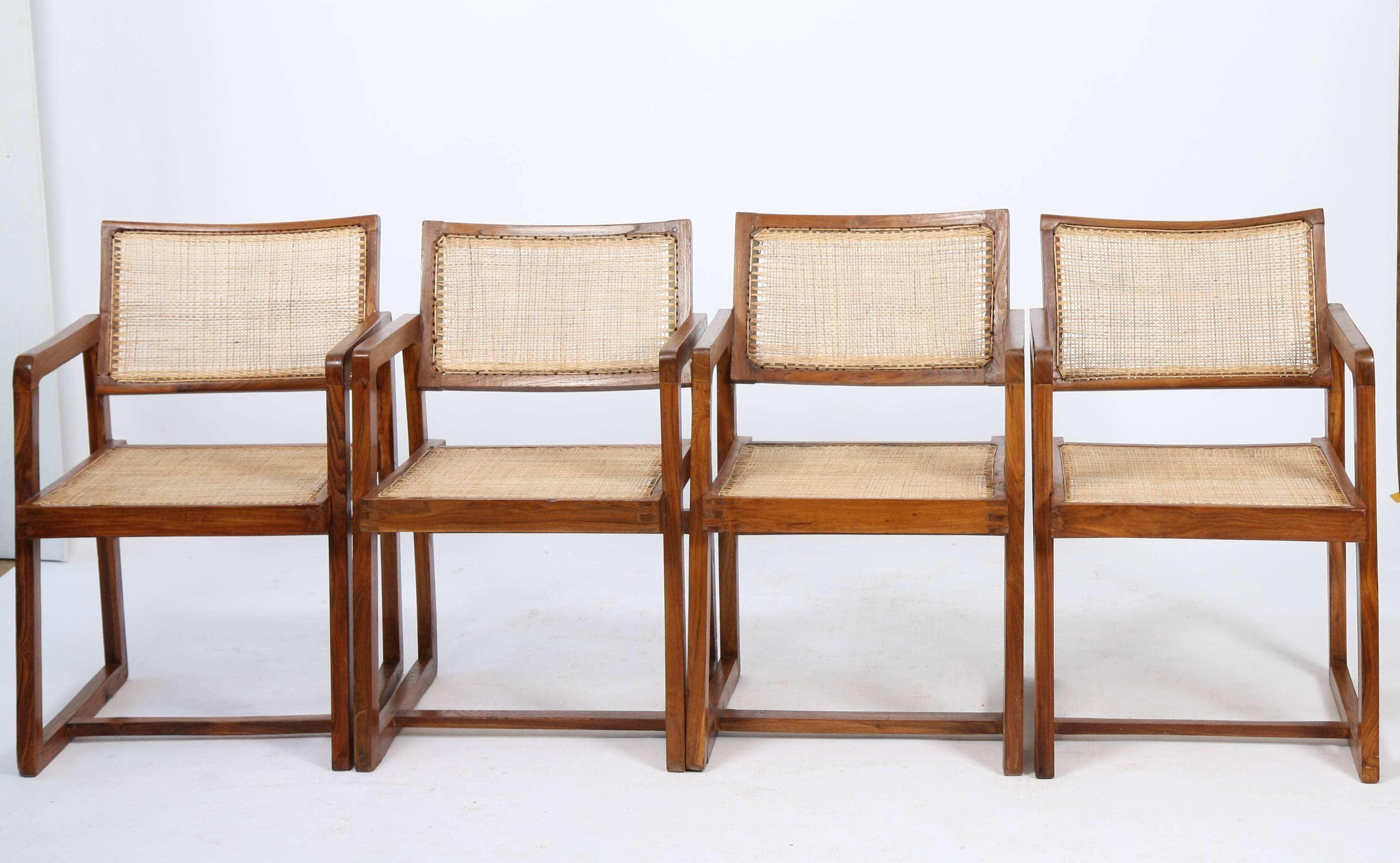 Pierre Jeanneret (1896-1967).
Set of four armchairs "Cane seat back office chair" in solid teak.
Double lateral legs "asymmetric framework", linked with two armrests crossbars.
Inclined and slightly curved backrest.
Restored