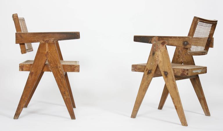 Pierre Jeanneret (1896-1967) set of two office cane elegant chairs.
In teak with inclined and slightly curved backrest.
Detached armrests and side
compass design armrests. Cane seat and backrest restored,
circa 1956.
Measures: Height 79 cm x length