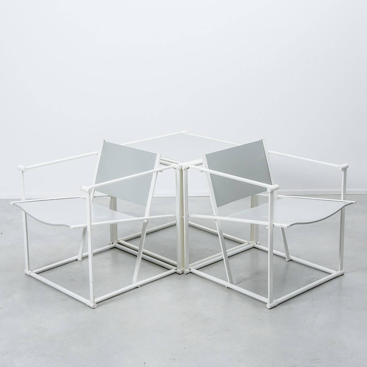 These two geometric chairs were designed by Radboud Van Beekum and manufactured by UMS Pastoe. They are constructed from white folded steel with grey powder coated ply seating. Following in the tradition of the De Stijl movement, the FM60 series is