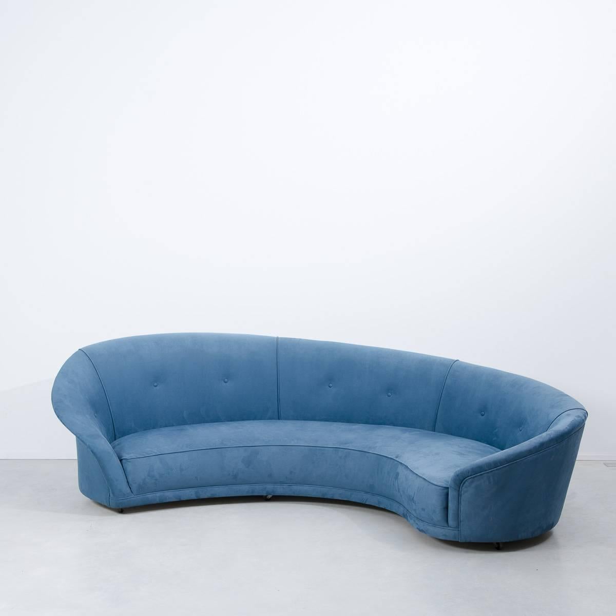 Bespoke made late 20th century curved sofa, kidney shaped in the manner of Vladimir Kagan. As far as we know, reclaimed from a theatre and reupholstered within the last decade with blue alcantara (a luxury suedette). 

Low sprung seat,