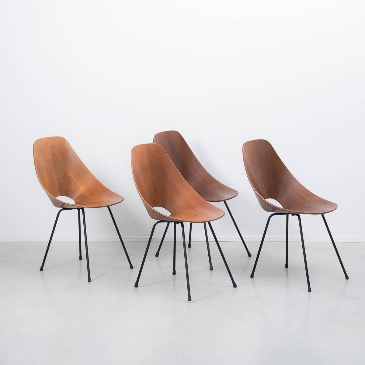 Italian molded plywood ‘Medea’ chairs designed by Vittorio Nobili for Fratelli Tagliabue in 1955. Molded teak wood seats are supported by black enamelled steel legs, accented with brass hardware. A perfect representation of the organic modern style.