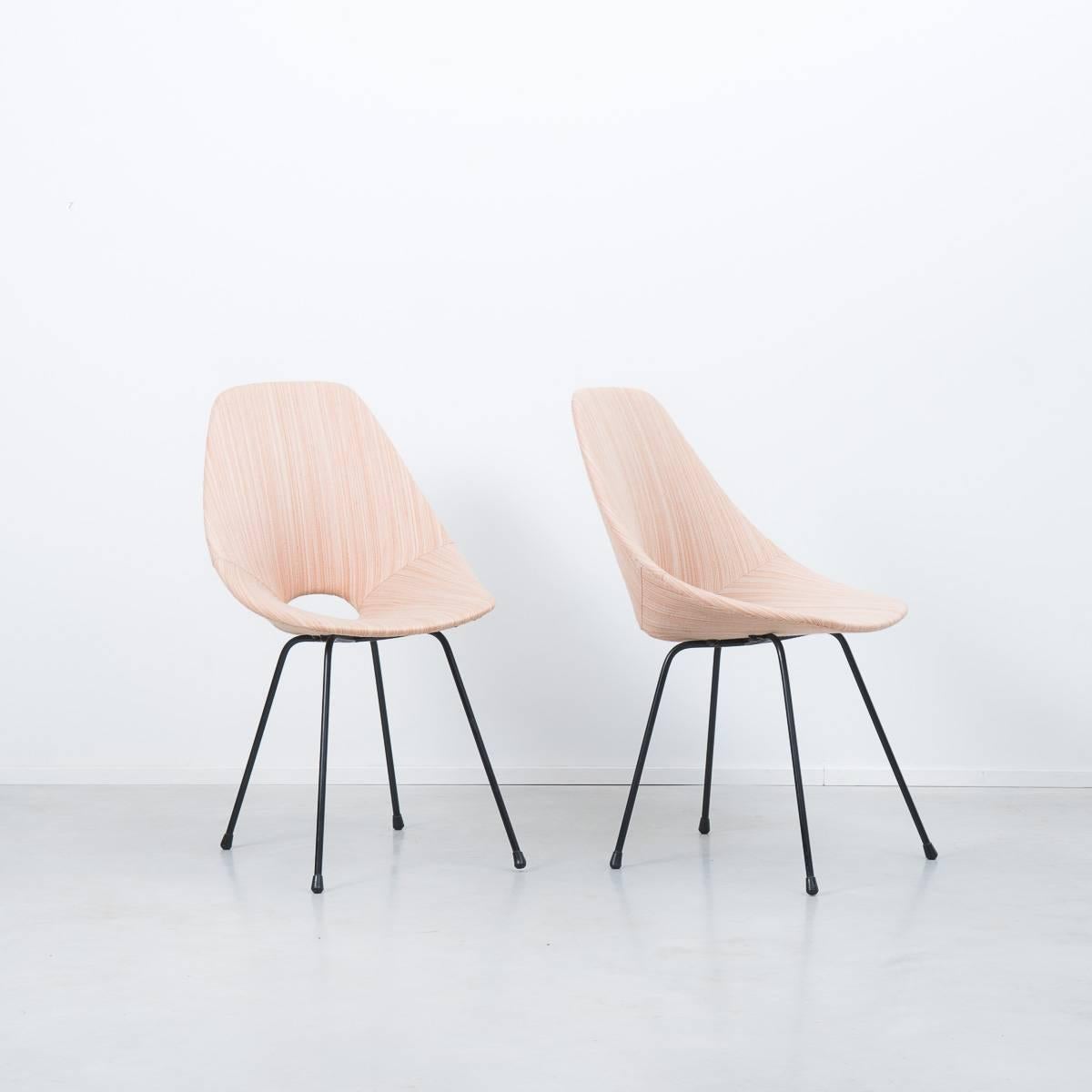A rare pair of Italian upholstered 'Medea' chairs designed by Vittorio Nobili for Brothers, Tagliabue in 1955. Their molded wooden seats are upholstered in their original rare soft blush fabric and supported by black enameled steel legs. The