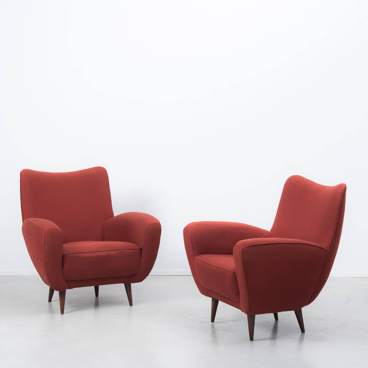 This pair of elegant 1950s Italian upholstered armchairs in the manner of Gio Ponti and Marco Zanuso. Their stylish silhouette is typical of this design period and they are upholstered in original terracotta fabric. In great condition, re-upholstery