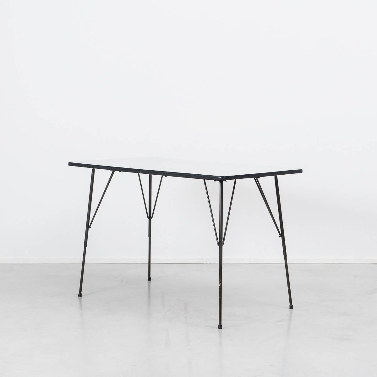 Rudolf Wolf dining table, designed in the 1950s for Elsrijk, Holland. A beautiful minimalistic design, it has a black metal frame and light grey formica top, edged in black. The height of the table is adjustable (46-77cm), so when low it is useable