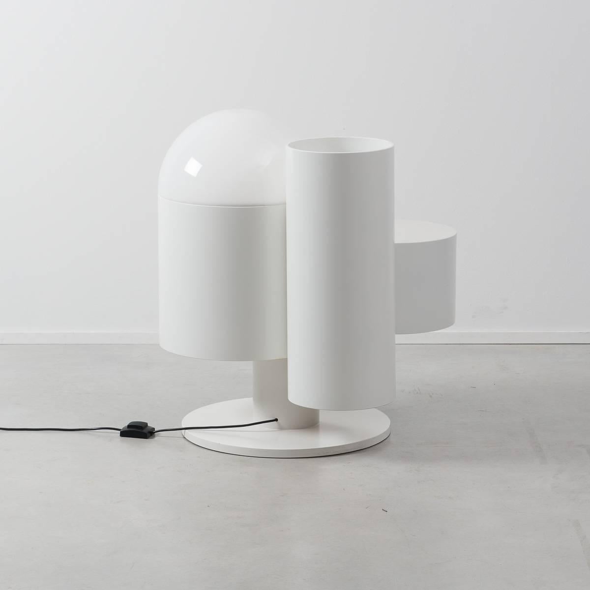This eye-catching Kerst Koopman floor lamp with shelf and storage cylinder is made from lacquered wood with an acrylic lampshade. Its staggered cylindrical forms are playful yet its muted white tones are restrained, creating an interesting futurist