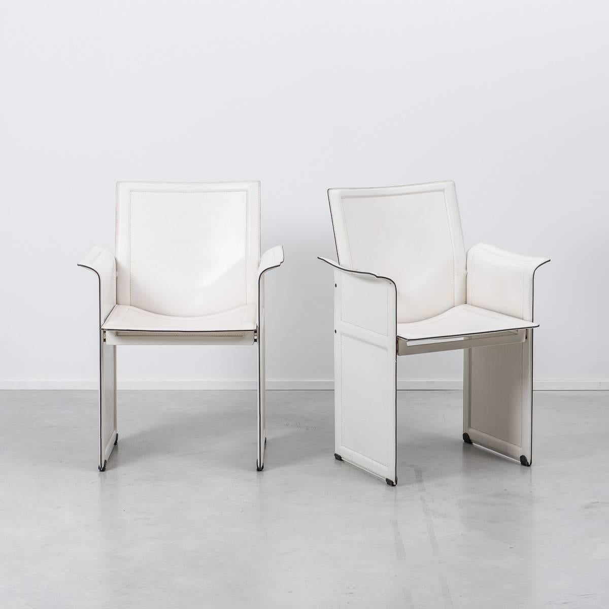 A pair of leather Korium chairs from Italian designer, Tito Agnoli for Matteo Grassi in the late 1970s, in white.

The chairs feature stitched and moulded leather on metal frame panels. The chairs are in moderate to good condition with general