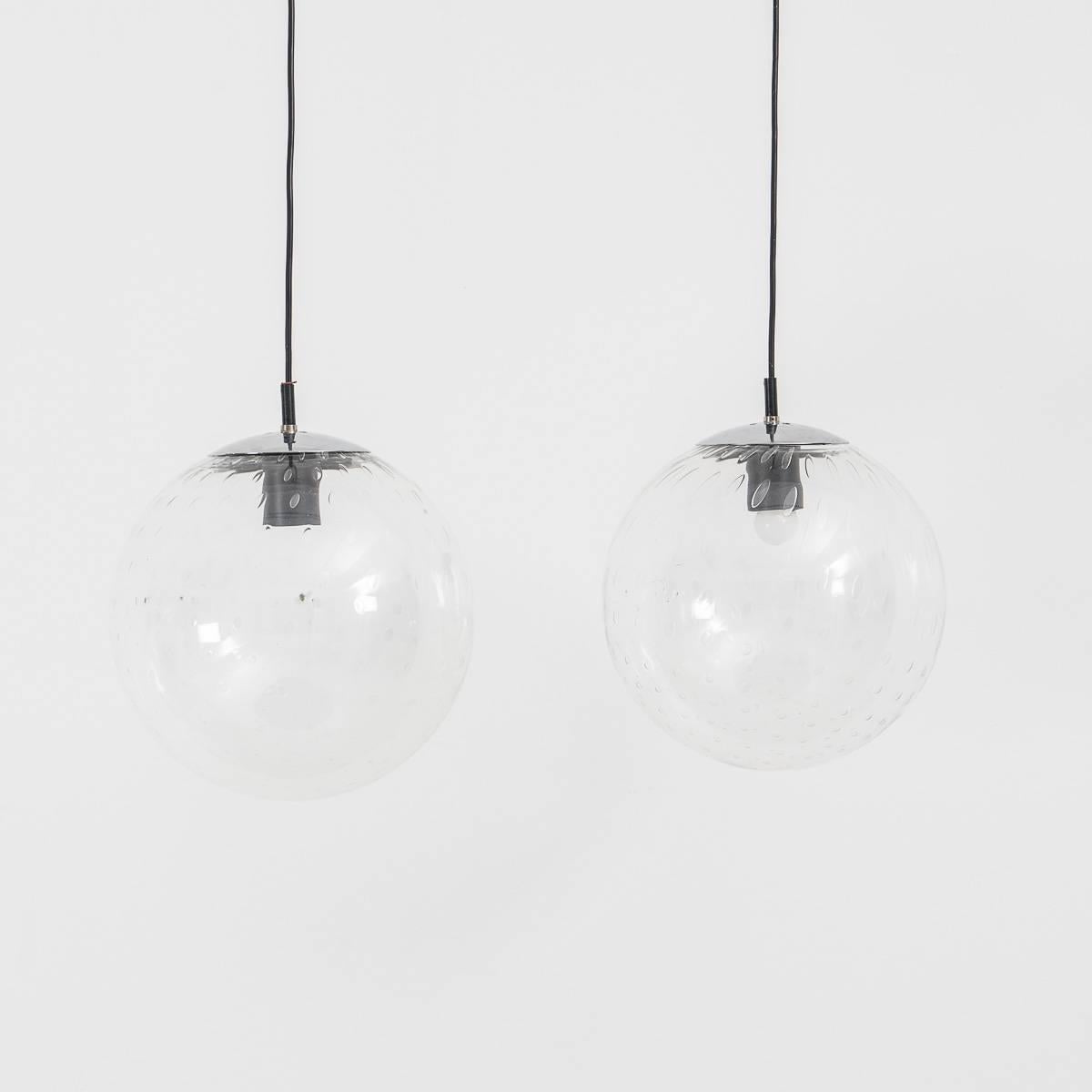 A pair of beautiful glass globe pendants by RAAK from the 1960s.

Currently with original wiring in working condition and can be rewired on request.

  