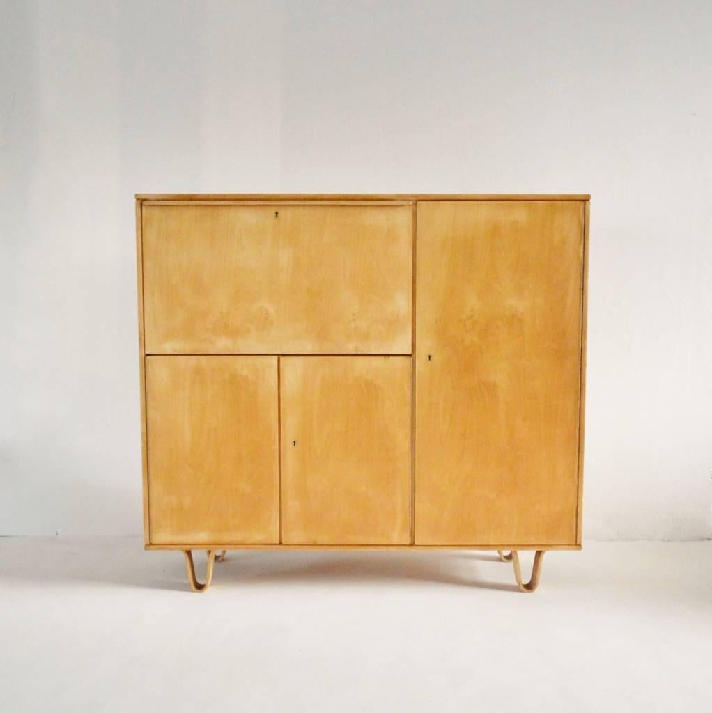 1950s birch cabinet, model CB01 cabinet designed by top Dutch designer Cees Braakman for UMS Pastoe, Netherlands. Constructed from birch ply there are shelves to the interior, a pull-out laminated desk with stationary drawers and two of Braakman's