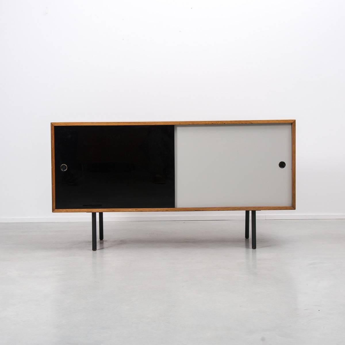 A glass and wood Robin Day sideboard designed for Hille, UK, 1950s.
The piece is from the Interplan range by the leading British furniture designer of the post war era. Vitrolite glass sliding doors sit inside a mahogany veneered cabinet which sits