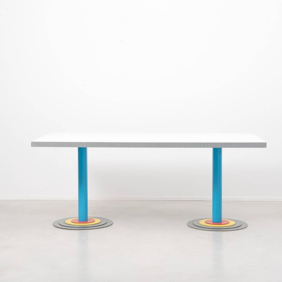 A striking and rare dining table that would also work well as a desk. Produced Driade, the company which Astori cofounded in 1968. The table has a formica top which sits on top of colored metal twin pedestals. A fantastic example of early Italian