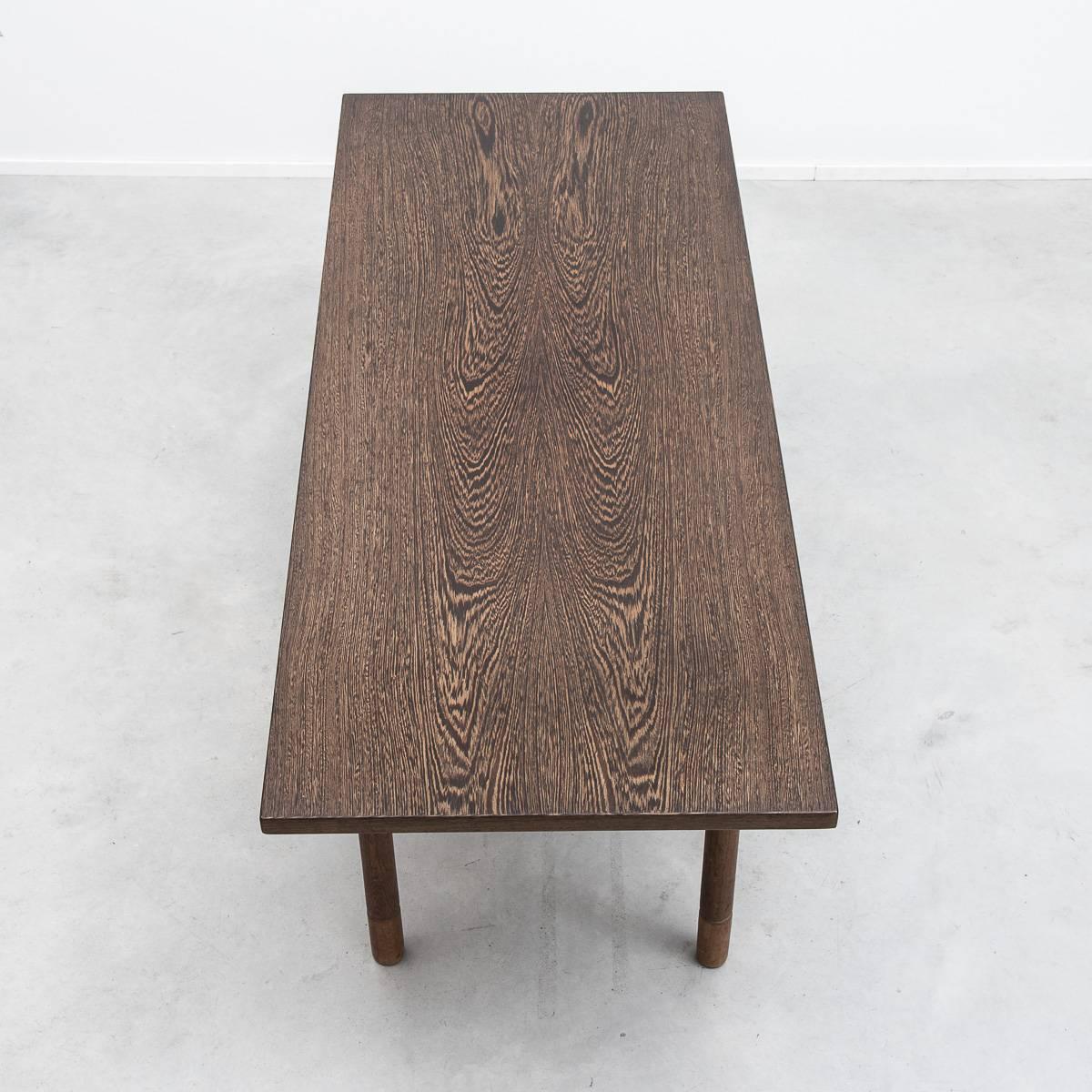 A rare and striking side table designed by the master of Danish design. The table has oak legs and an unusual and graphic wenge veneered surface. The underside is branded with the mark of the manufacturer Andreas Tuck indicating it belongs to an