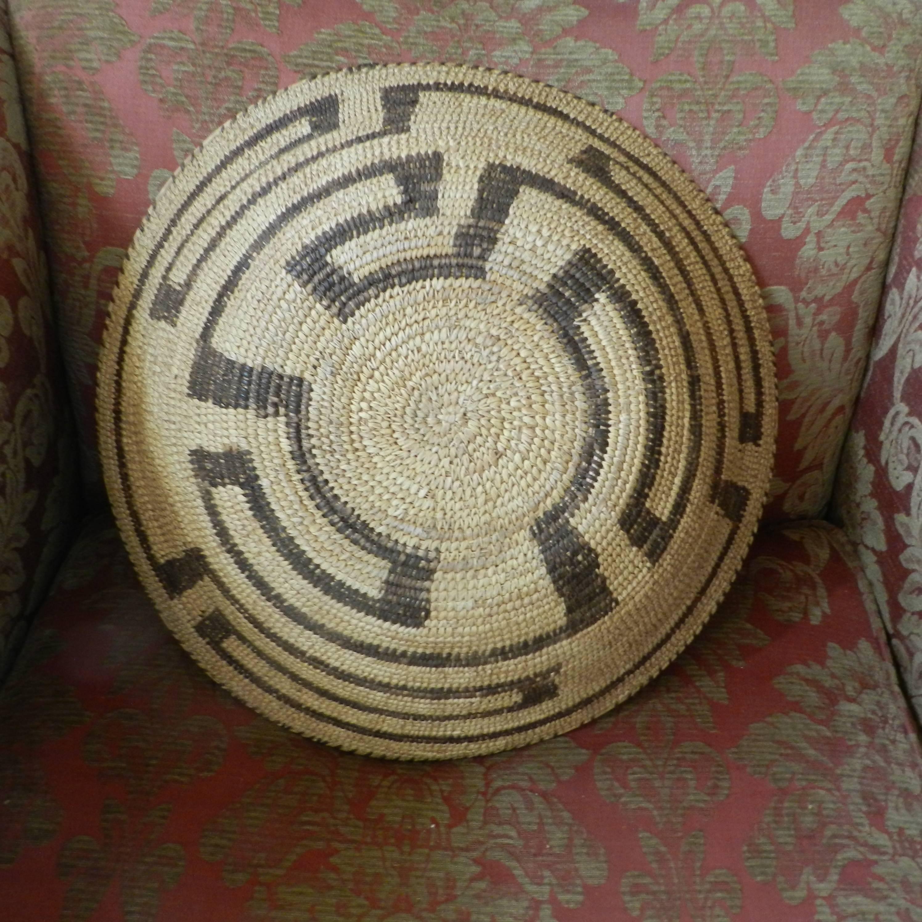 This very large Arizona Papago basket has a nice geometric design, circa 1930s. A few stitches missing on the rim. Measures: 19