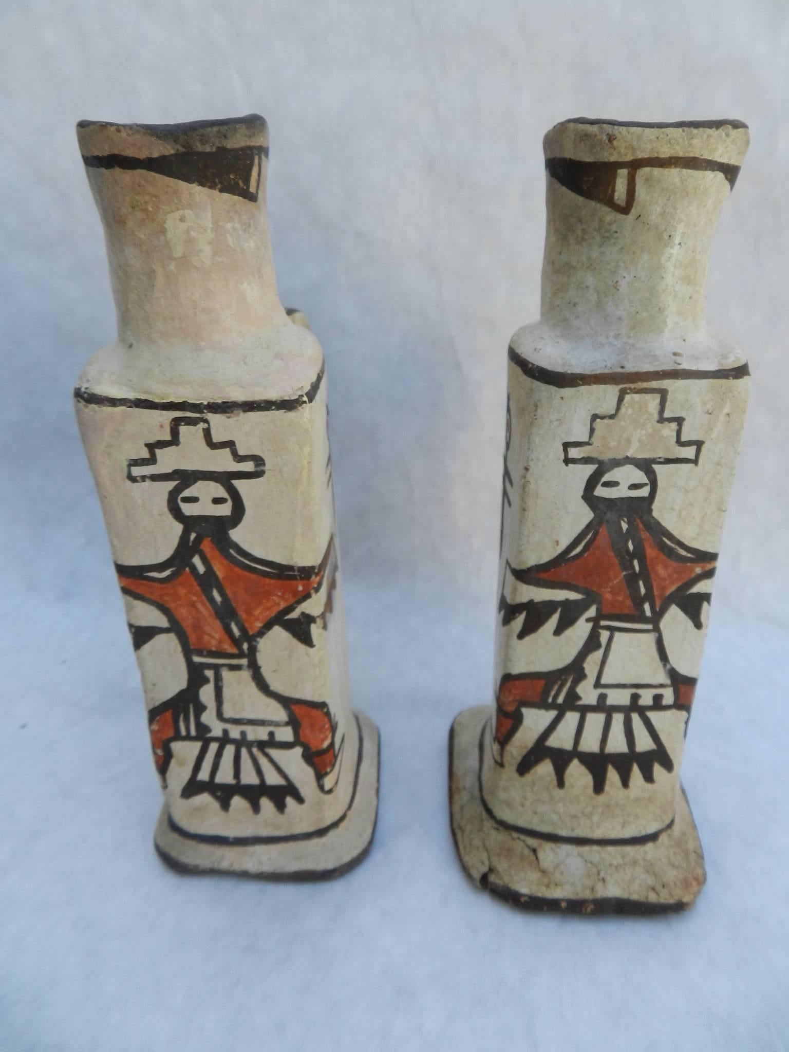 These rare antique pair of Zuni Pueblo candleholders have kachina figures and dragonflys.