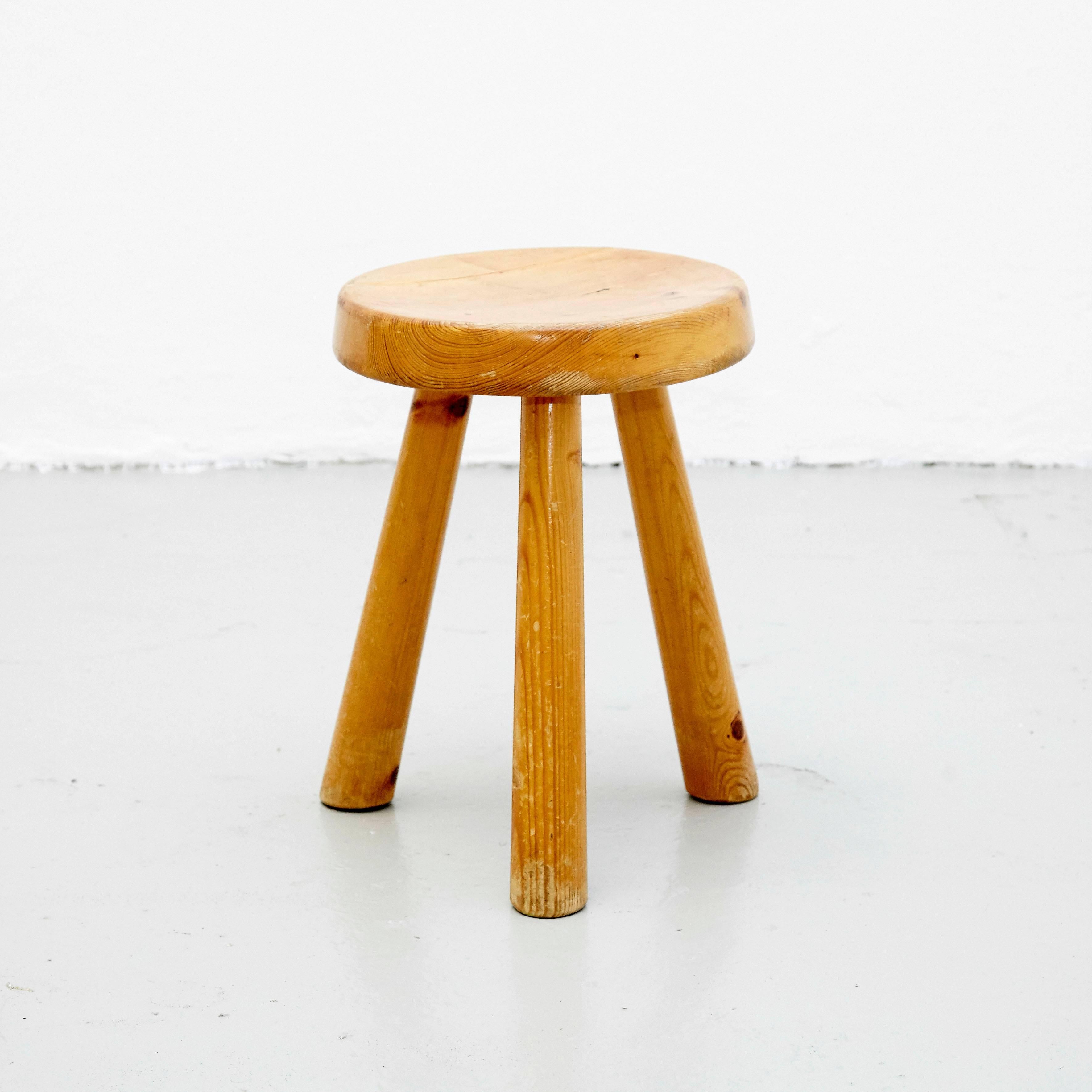 Stool designed by Charlotte Perriand around 1960 for Les Arcs.
Manufactured in France.
Lacquered metal base, pine wood seat.

In good original condition, preserving a beautiful patina. It has a restauration from the legs as shown in the