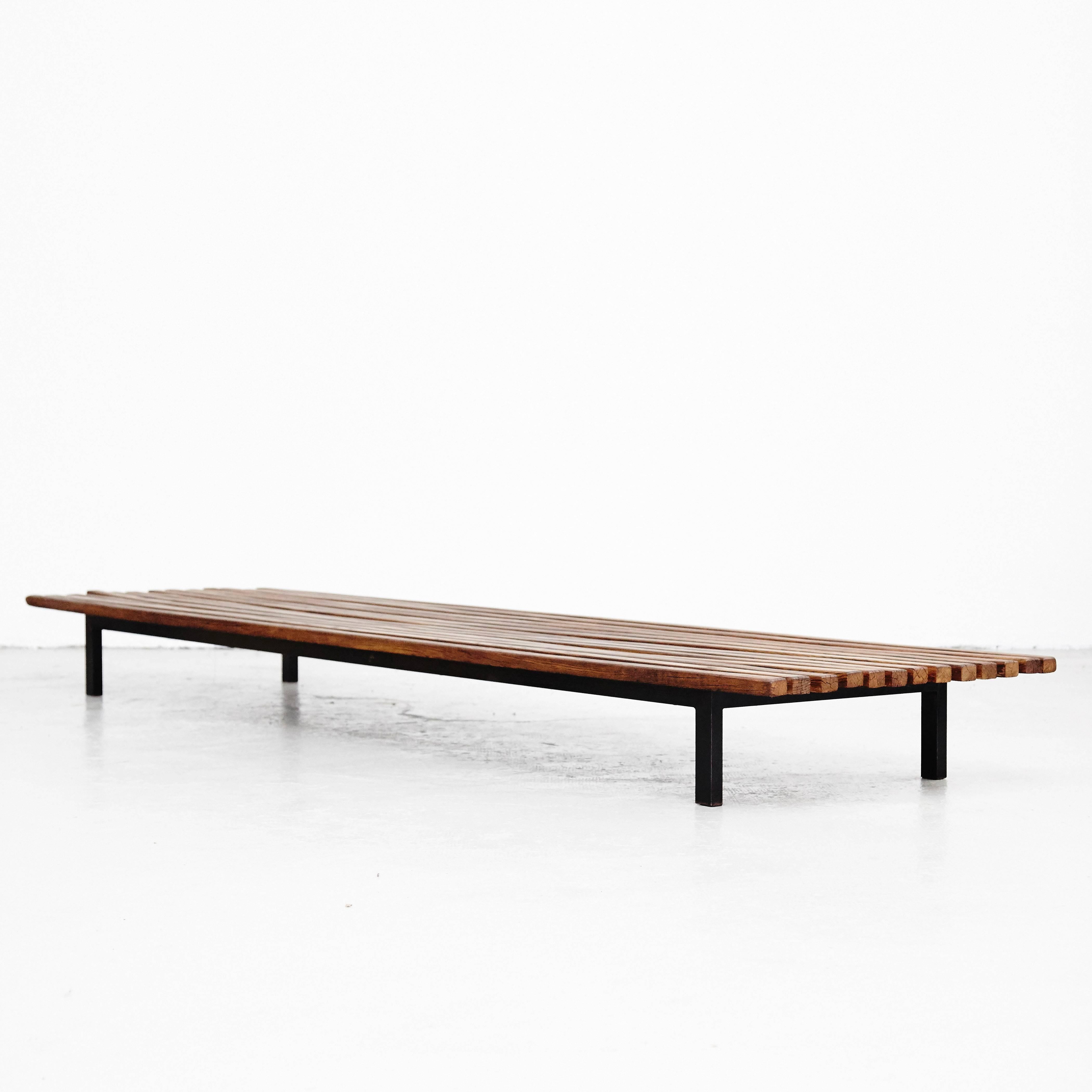 Bench designed by Charlotte Perriand, circa 1950.
This model is with 13 slats of wood.

Wood, metal frame legs.

Provenance: Cansado, Mauritania (Africa).

In good original condition, with minor wear consistent with age and use, preserving a