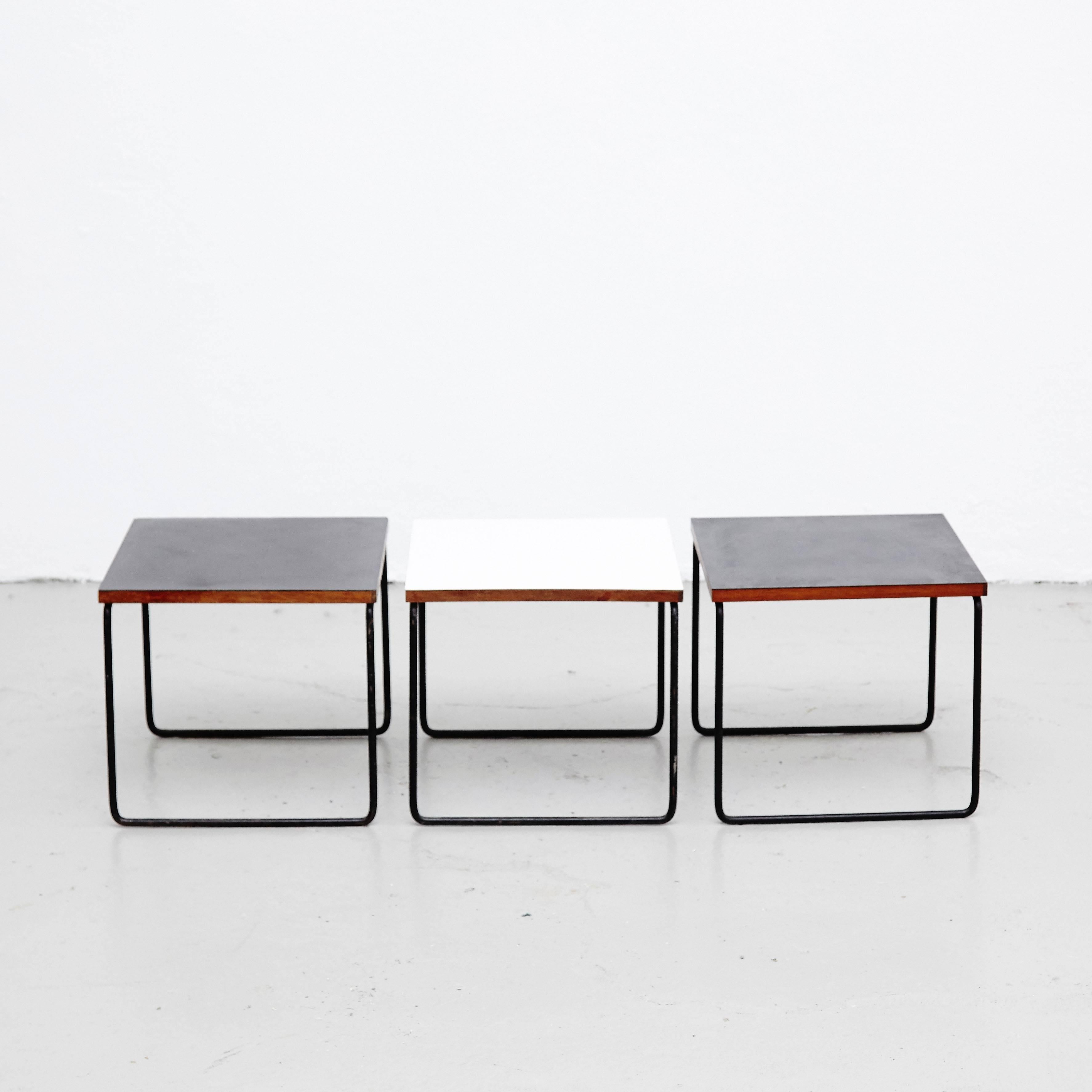 Tables designed by Pierre Guariche. 
Manufactured by Steiner, (France), circa 1950. 
Bent and painted iron frame, laminated wood. 

In good original condition, with minor wear consistent with age and use, preserving a nice patina. 

Guariche